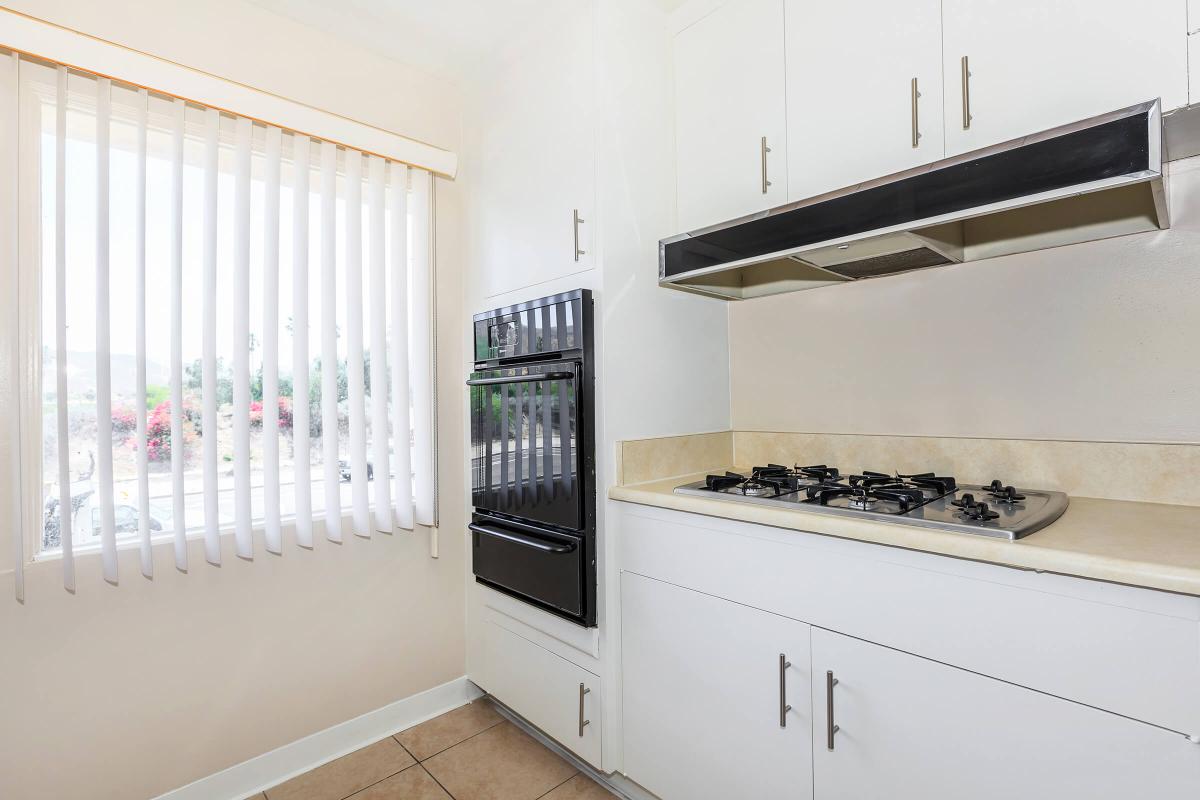 a kitchen with a stove top oven sitting inside of a building