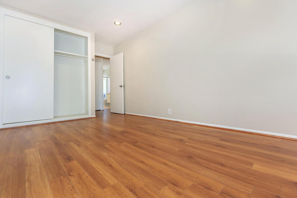 a large empty room with a wooden floor