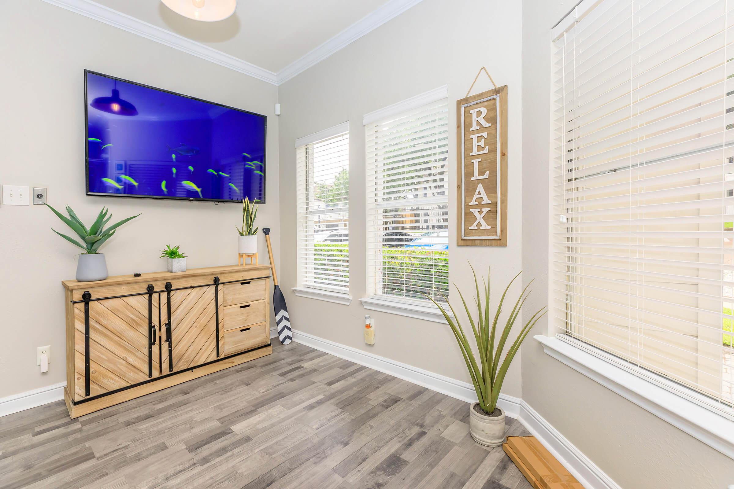 a living room filled with furniture and a large window