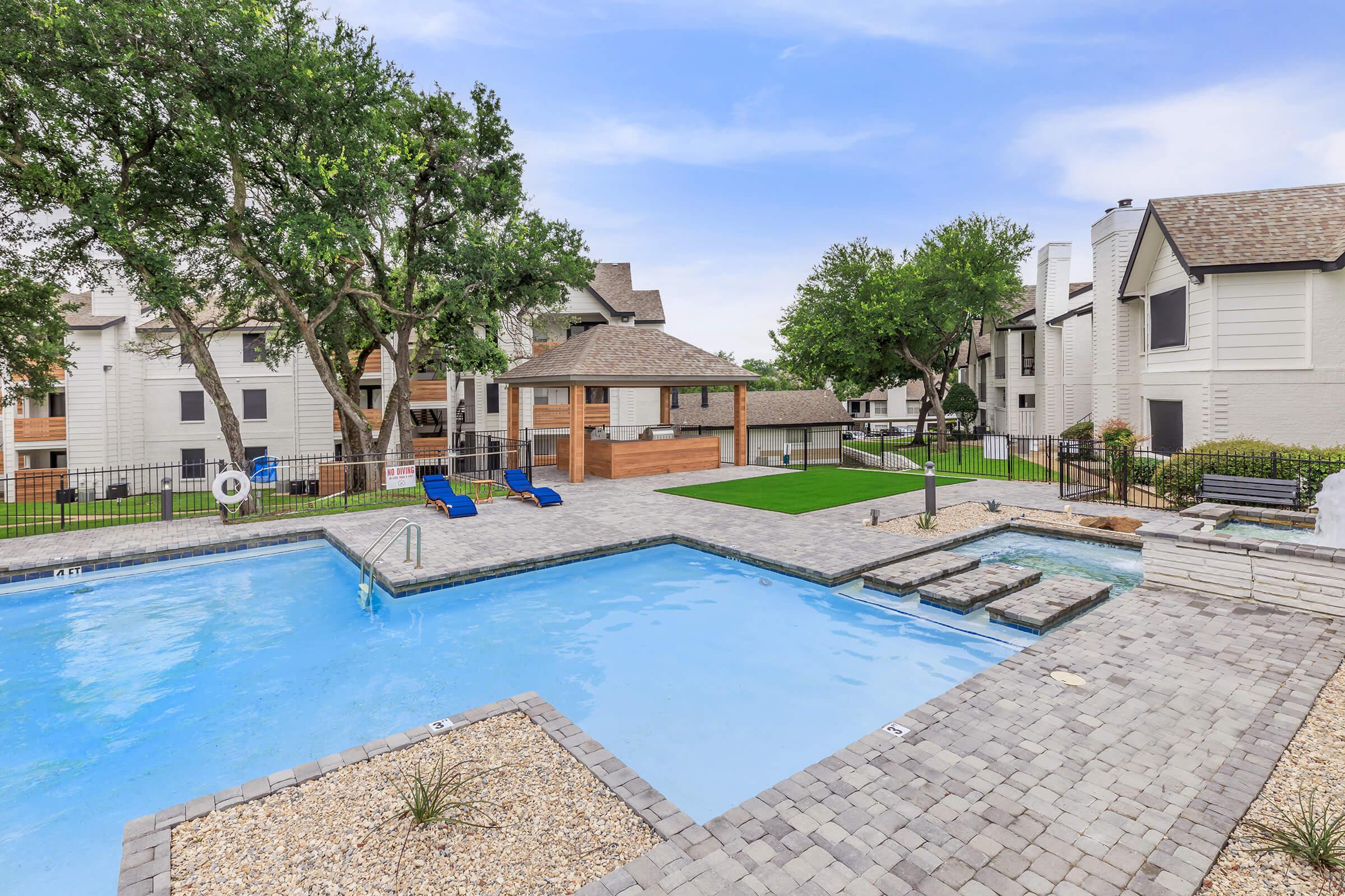 a house with a pool outside of a building