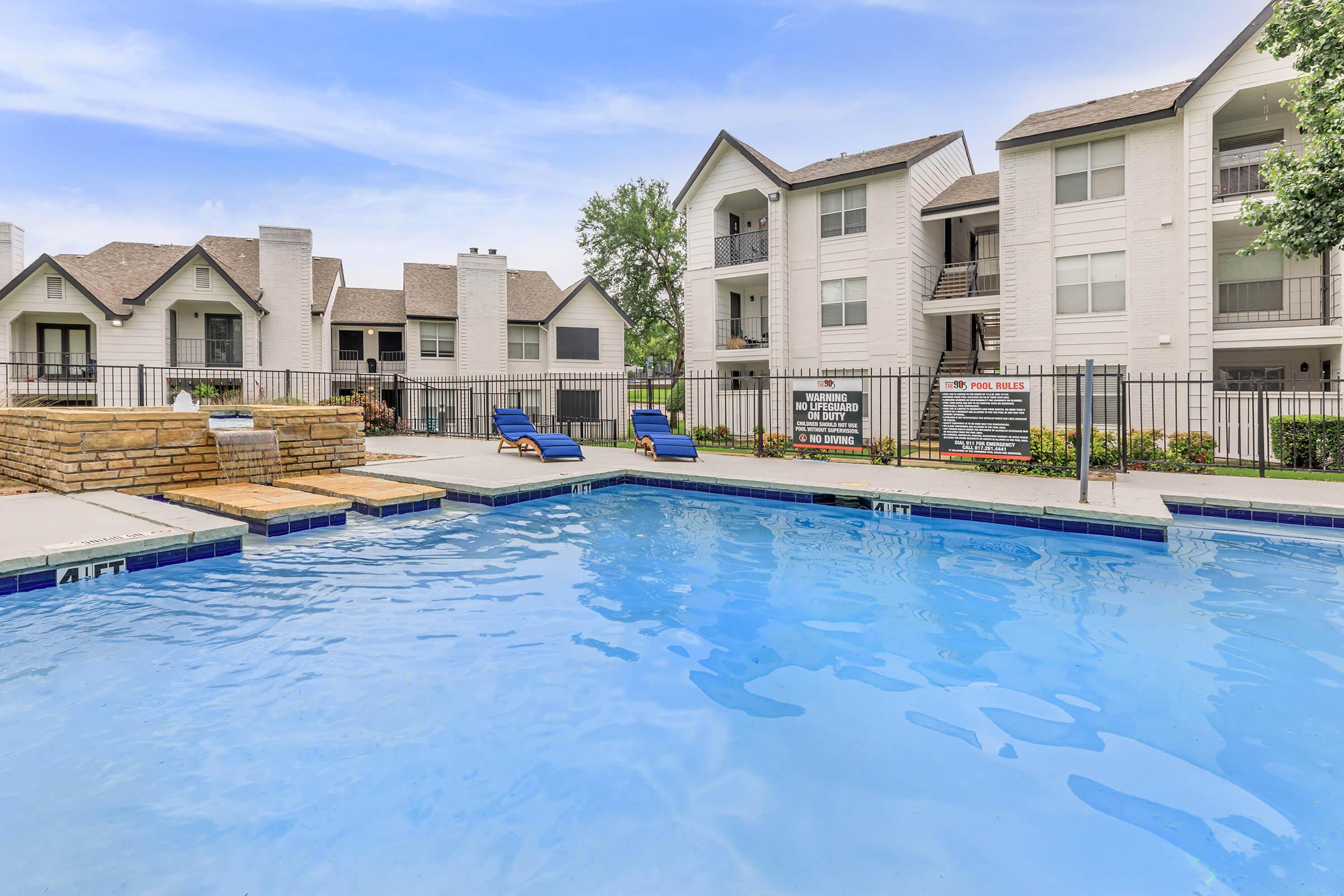 a large pool of water in front of a house