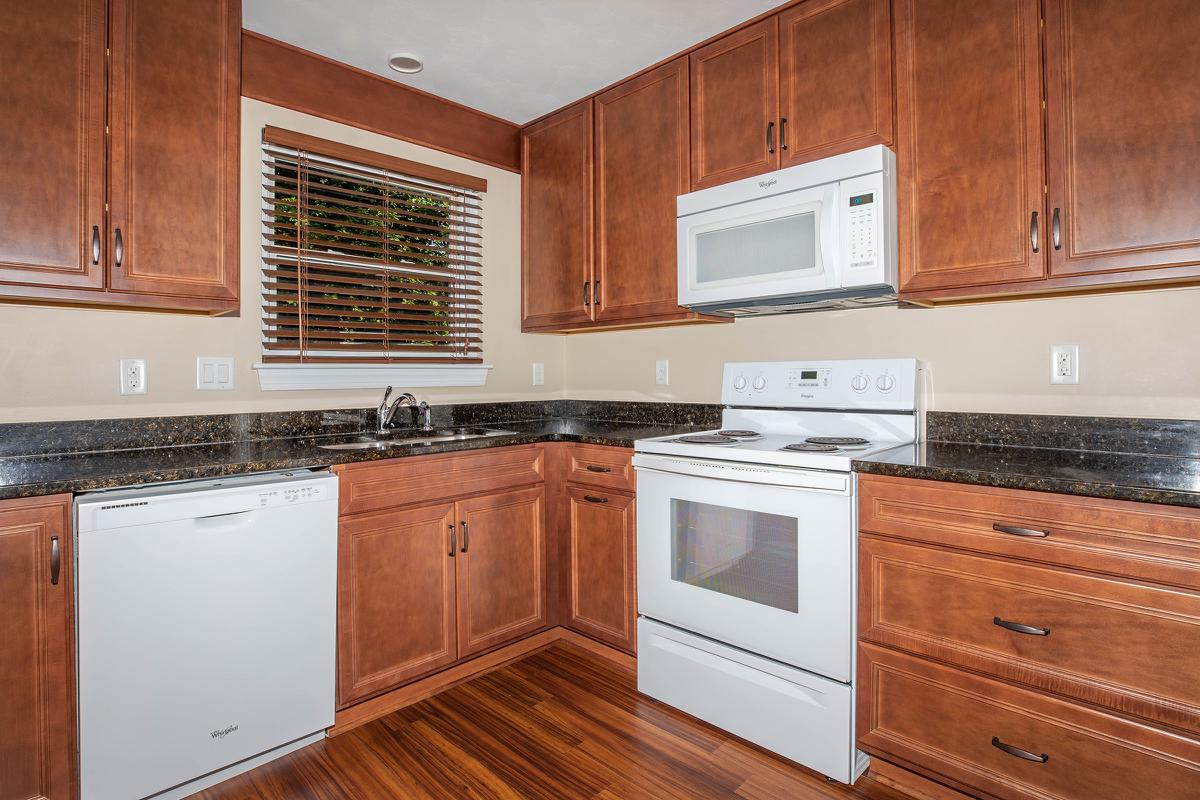 a kitchen with stainless steel appliances and wooden cabinets