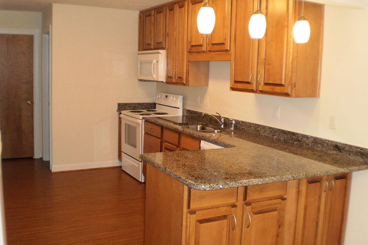 a kitchen with stainless steel appliances and wooden cabinets