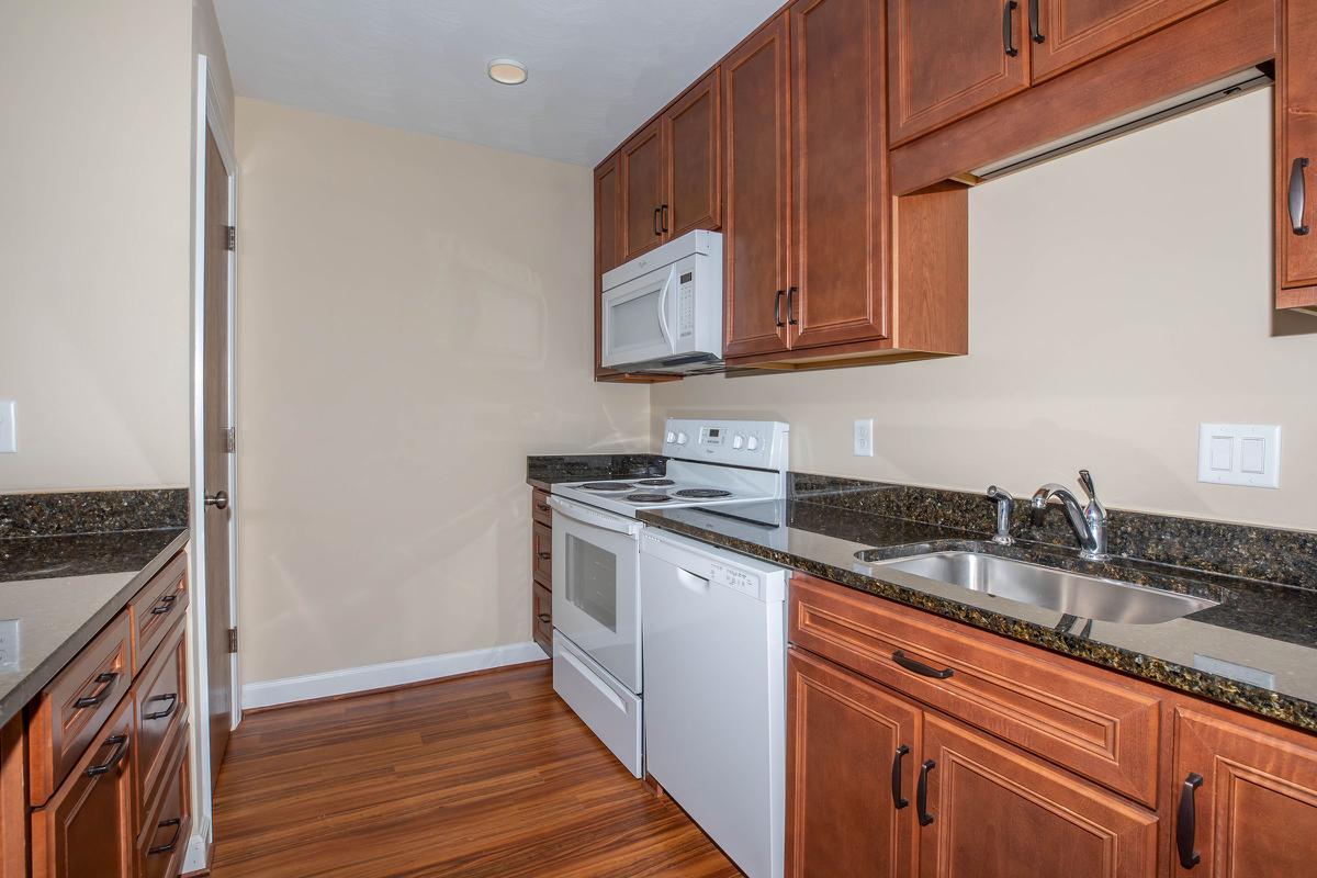 a kitchen with stainless steel appliances and wooden cabinets
