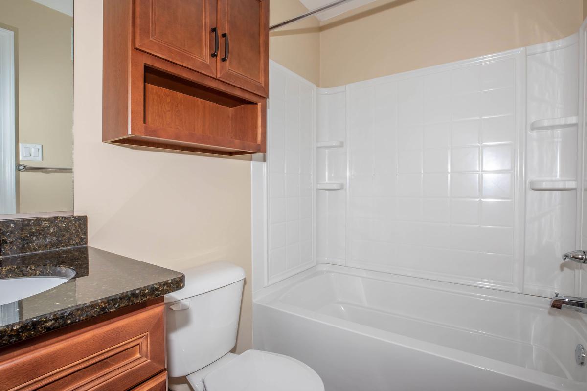 a white tub sitting next to a sink