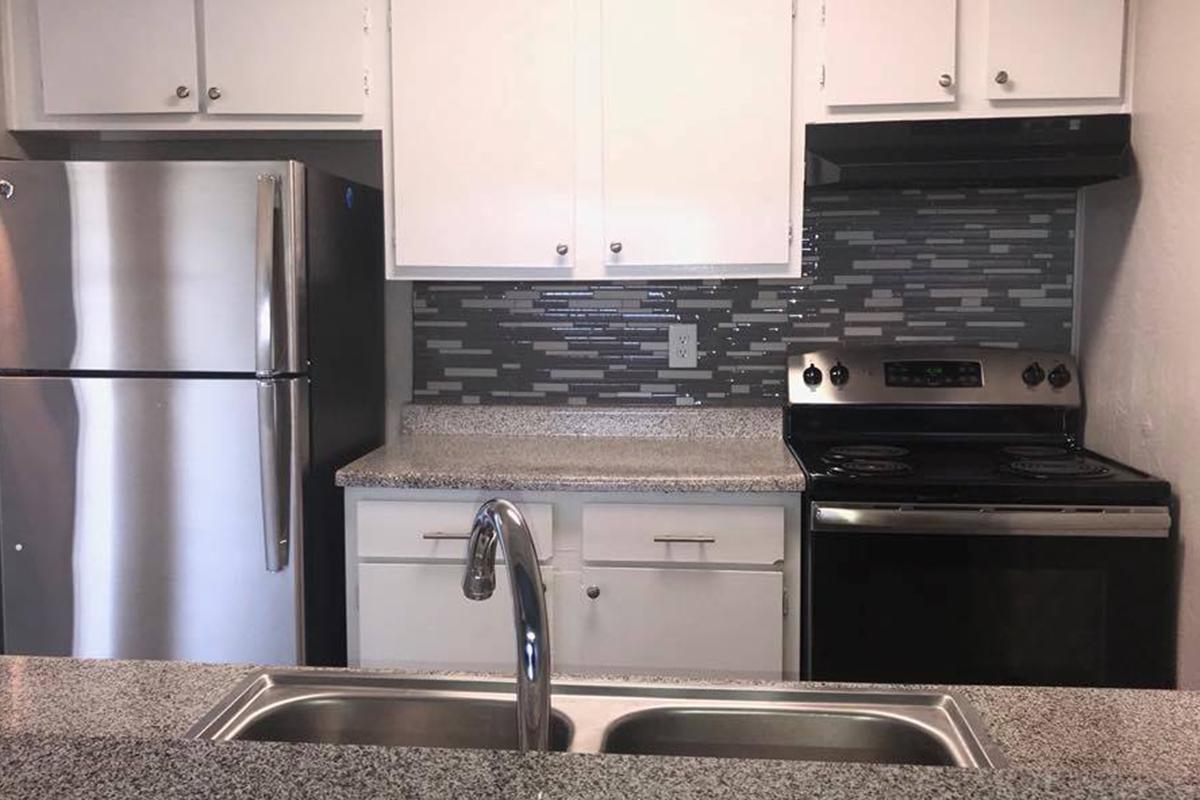 a stove top oven sitting inside of a kitchen