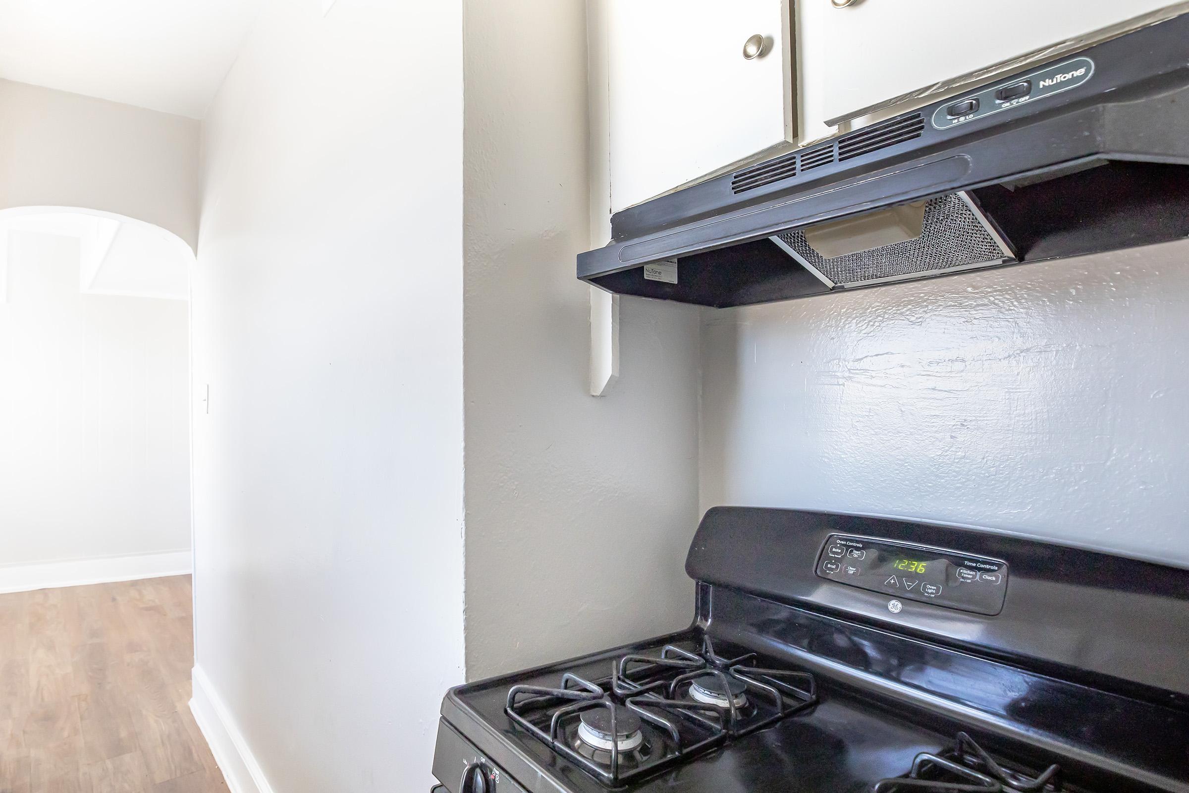 a stove top oven sitting inside of a kitchen