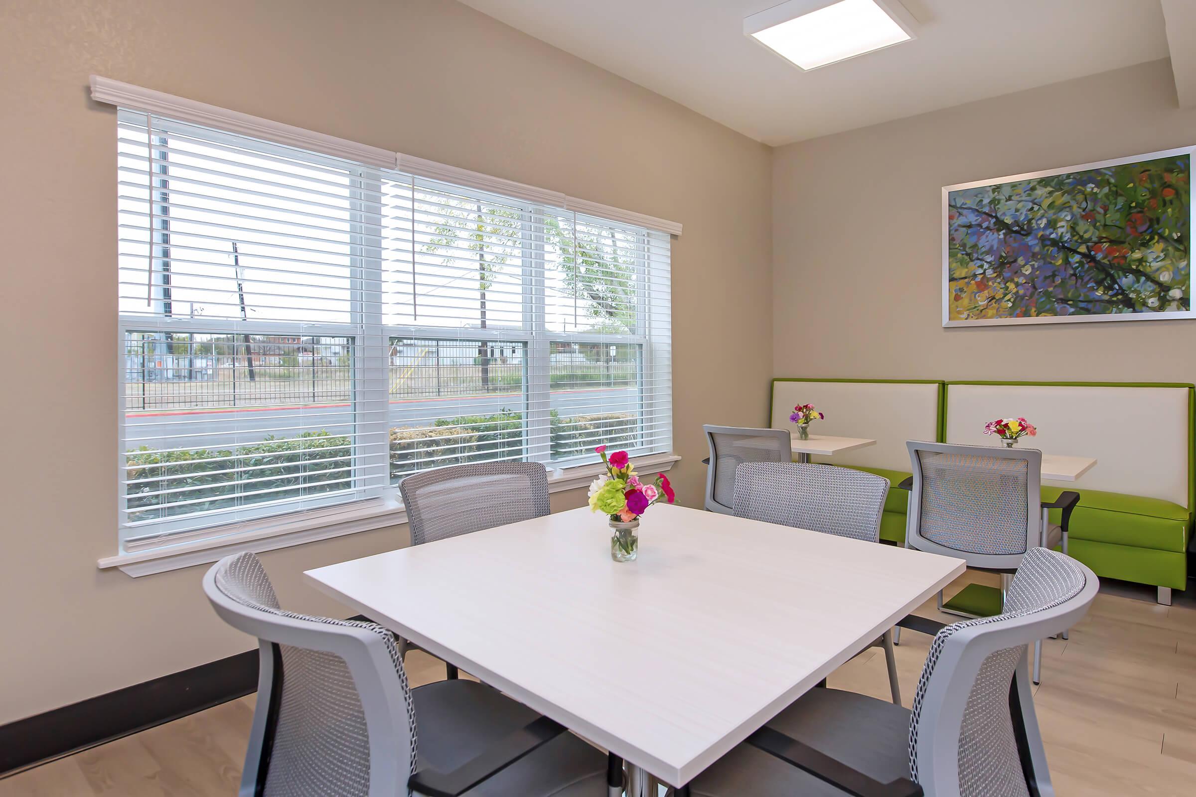 a dining room table in front of a window