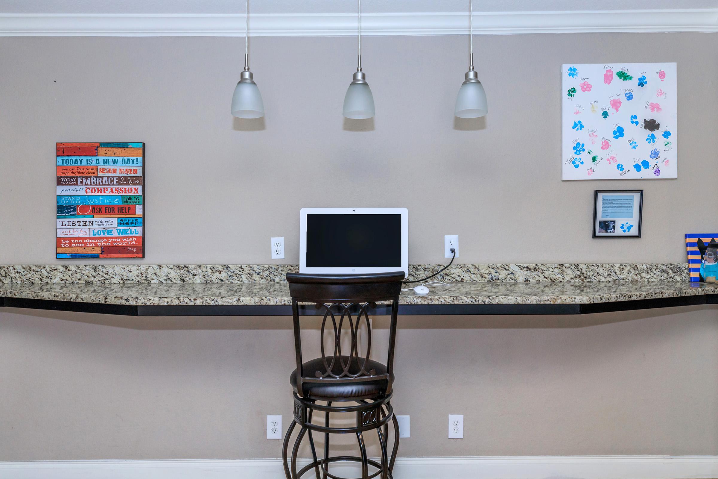 a desk with a computer on a table