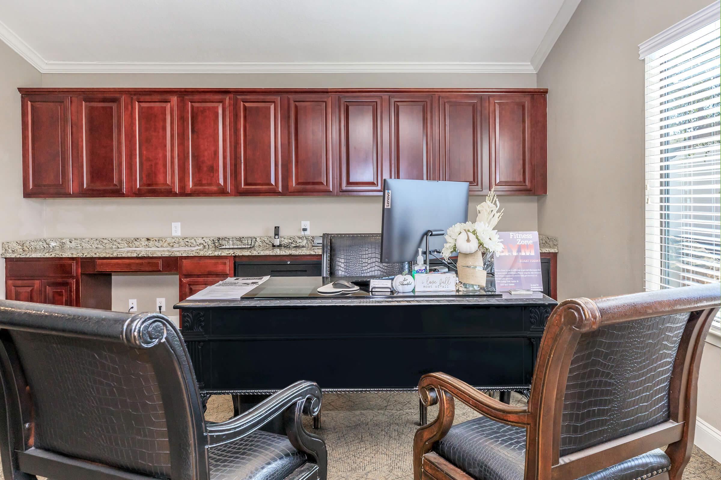 a kitchen with a table and a chair in a room