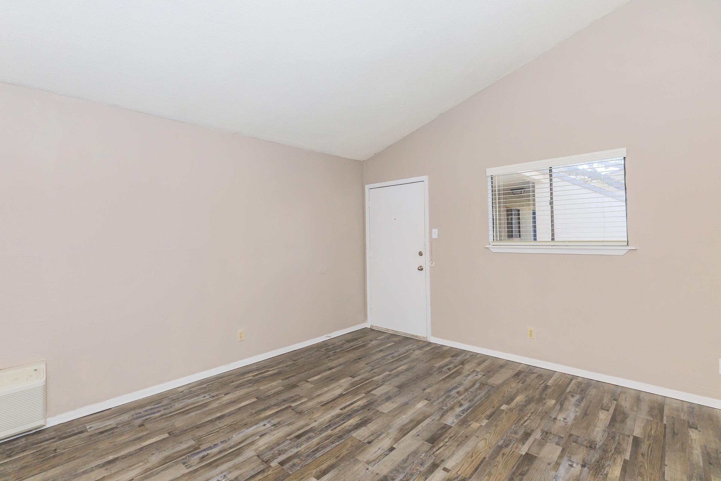 a bedroom with a wooden floor