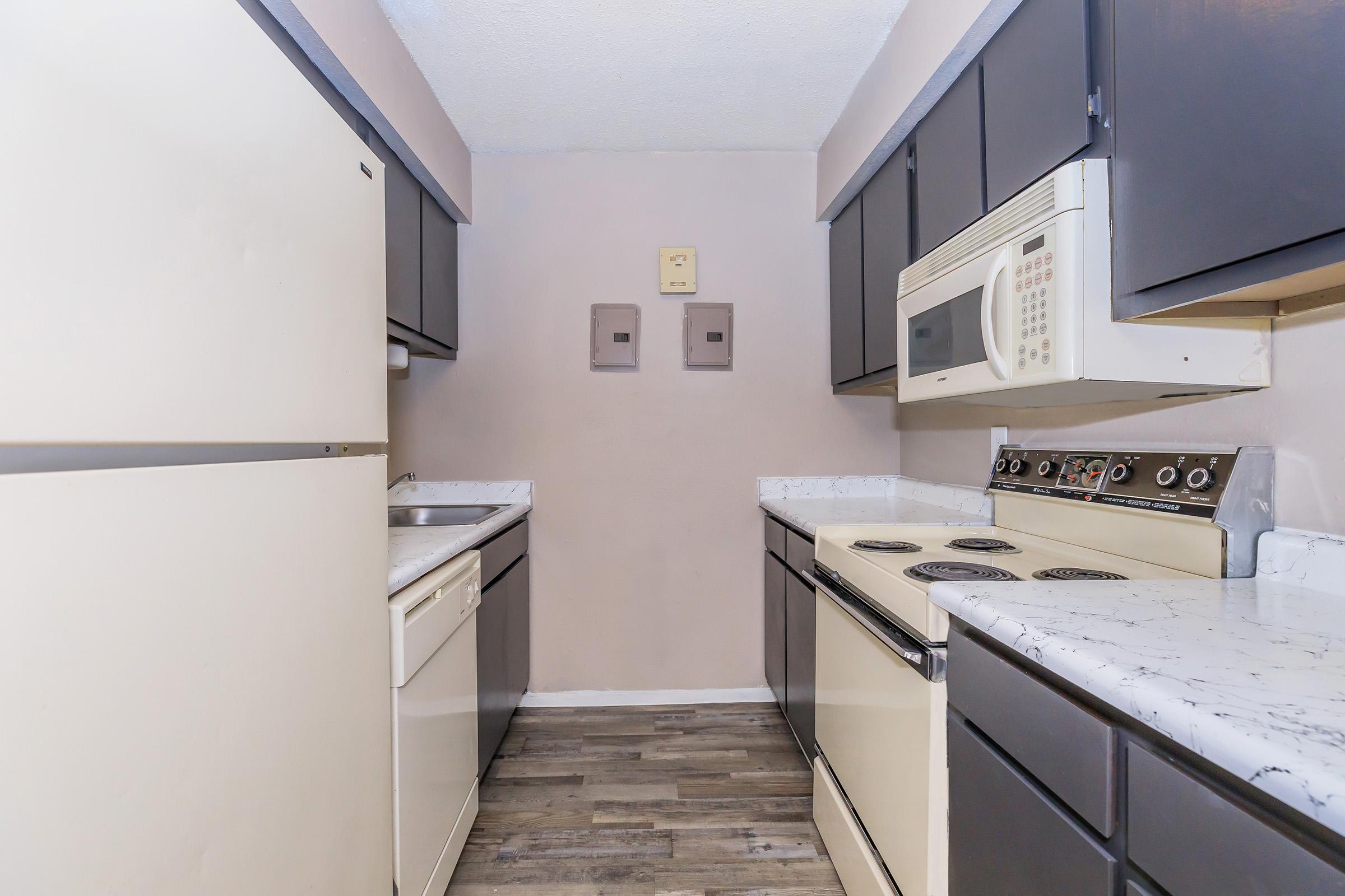 a kitchen with a sink and a refrigerator