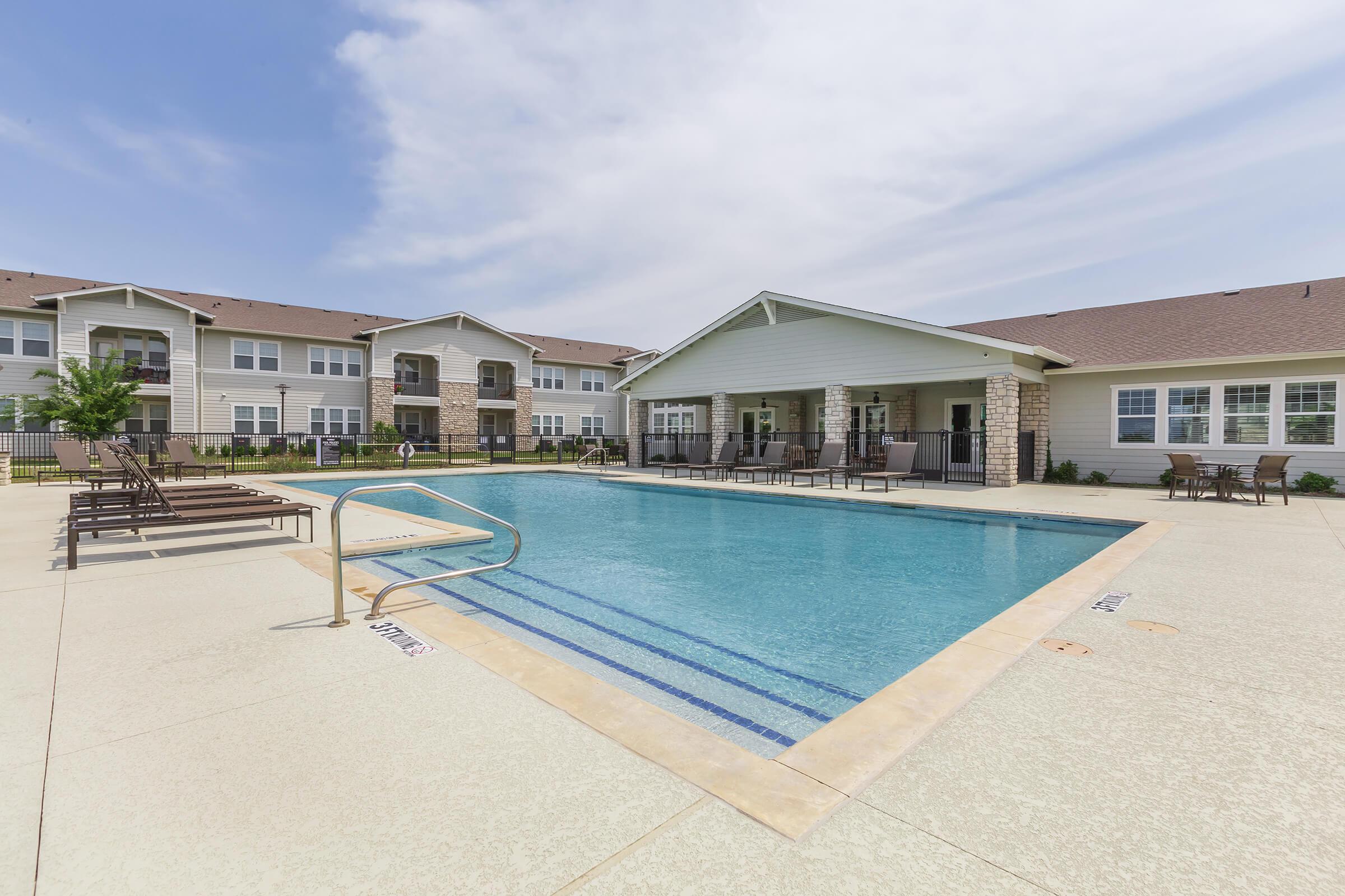 a house with a pool in front of a building