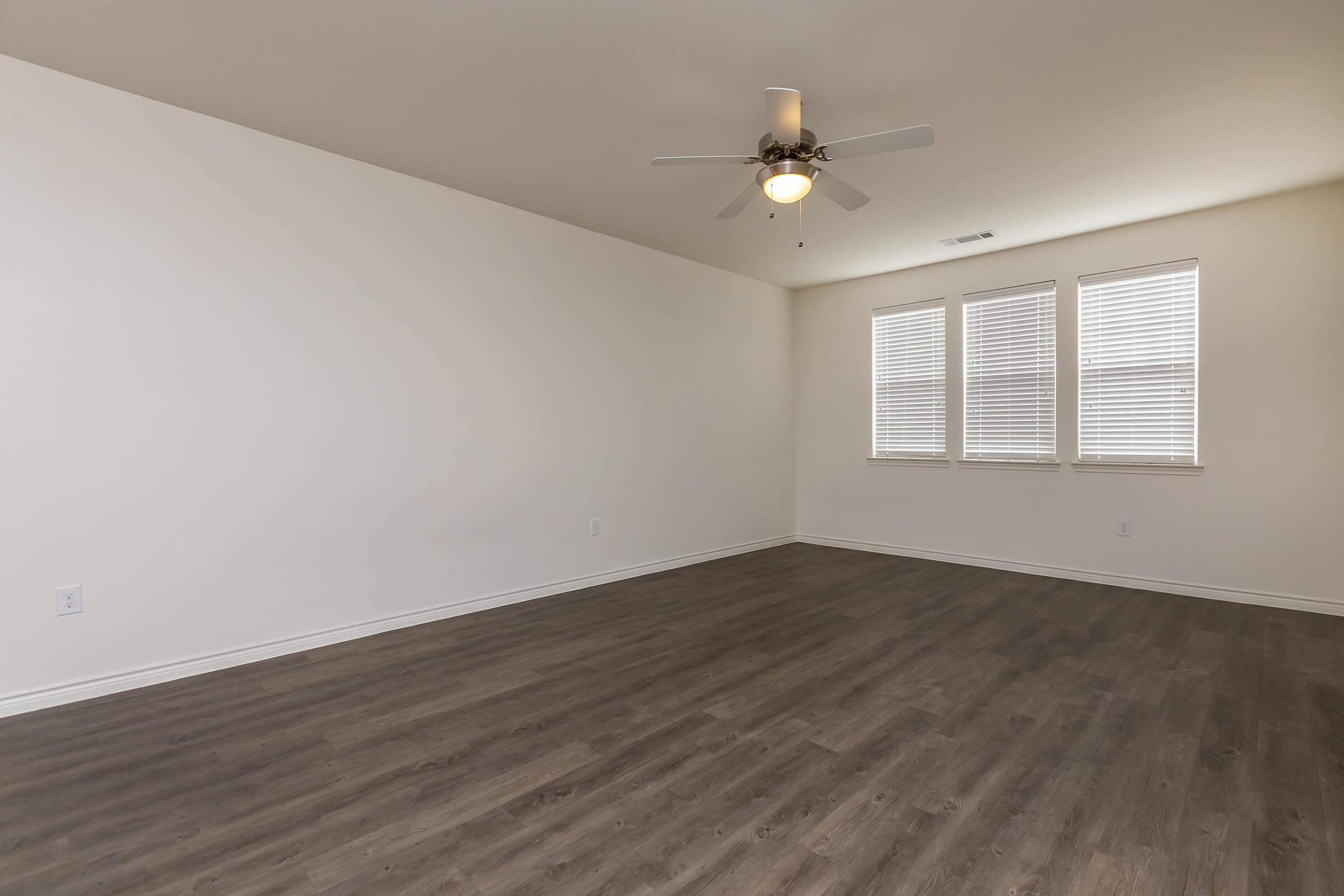 a bedroom with a wood floor