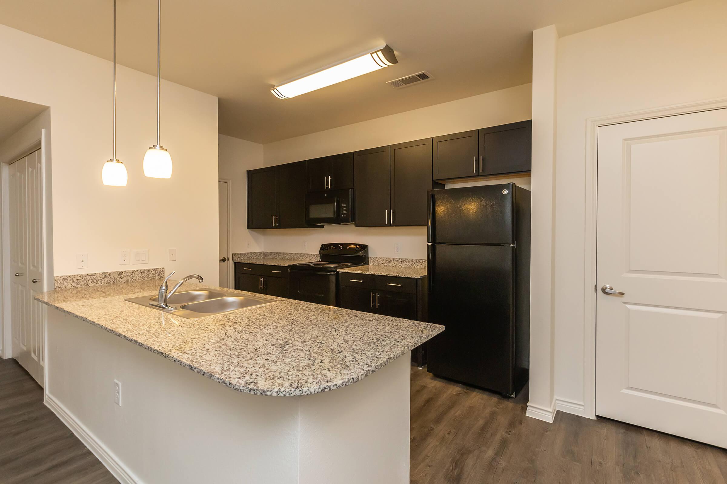 a kitchen with a sink and a mirror