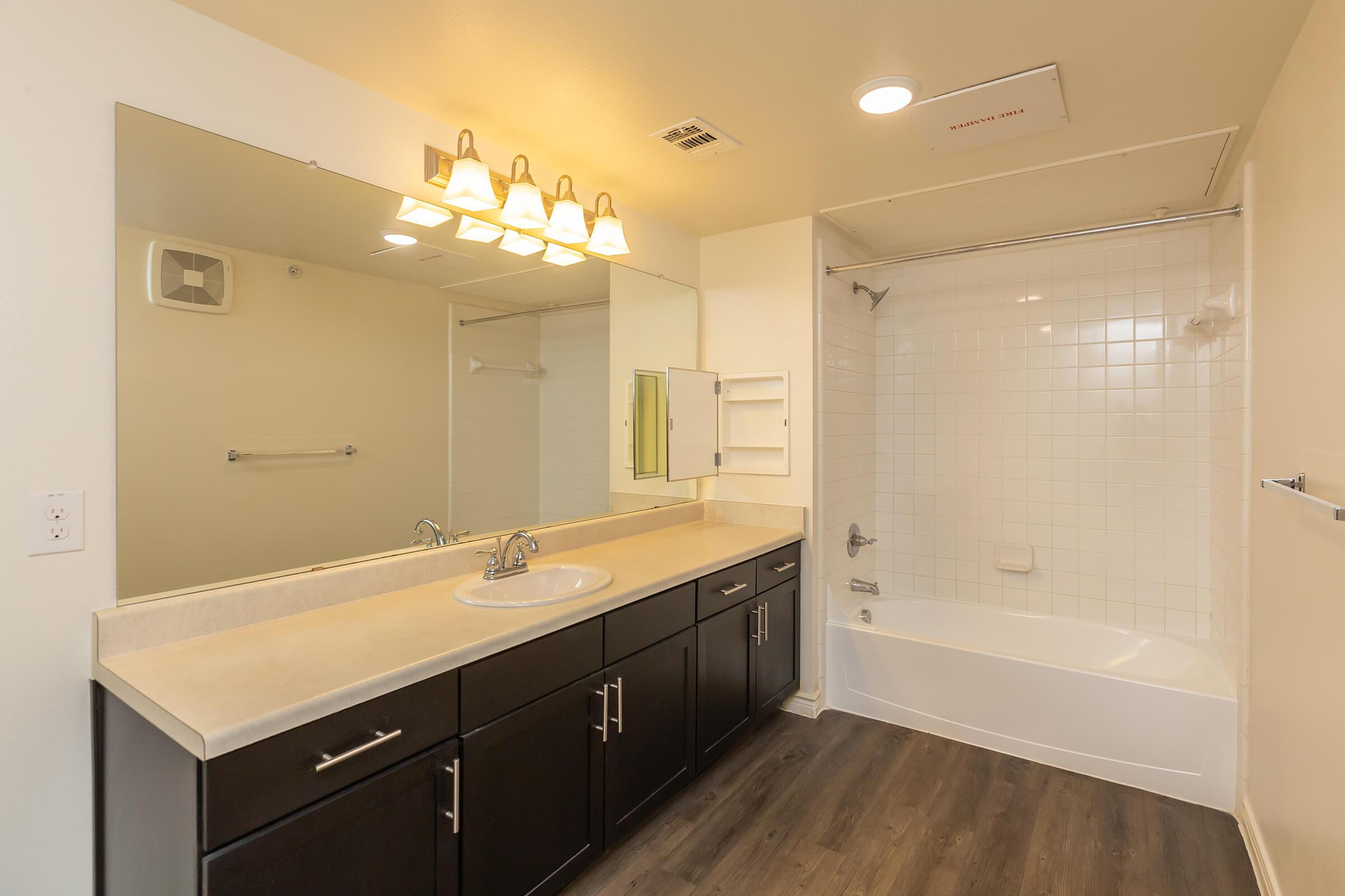 a kitchen with a sink and a mirror