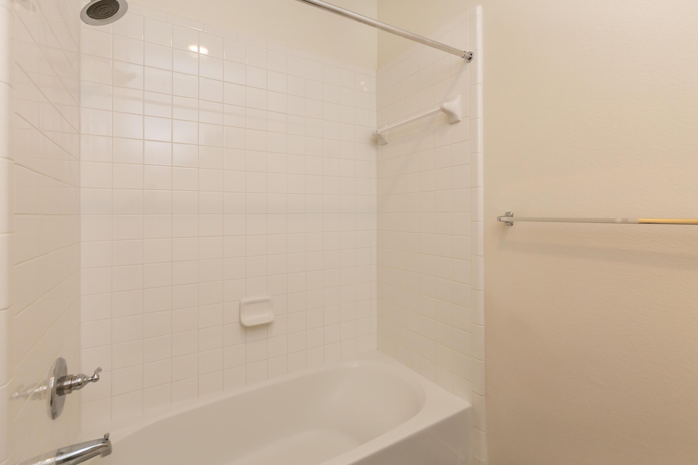 a white tub sitting next to a shower