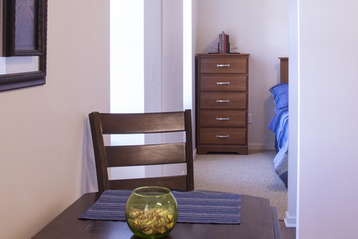 a bedroom with a bed and desk in a small room