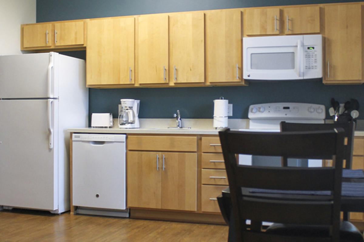 a white refrigerator freezer sitting inside of a kitchen