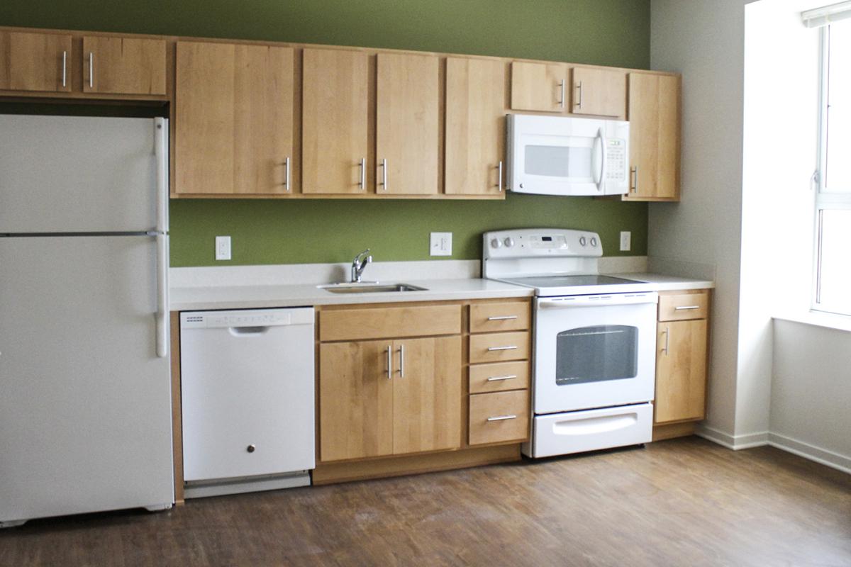 a kitchen with a stove and a refrigerator