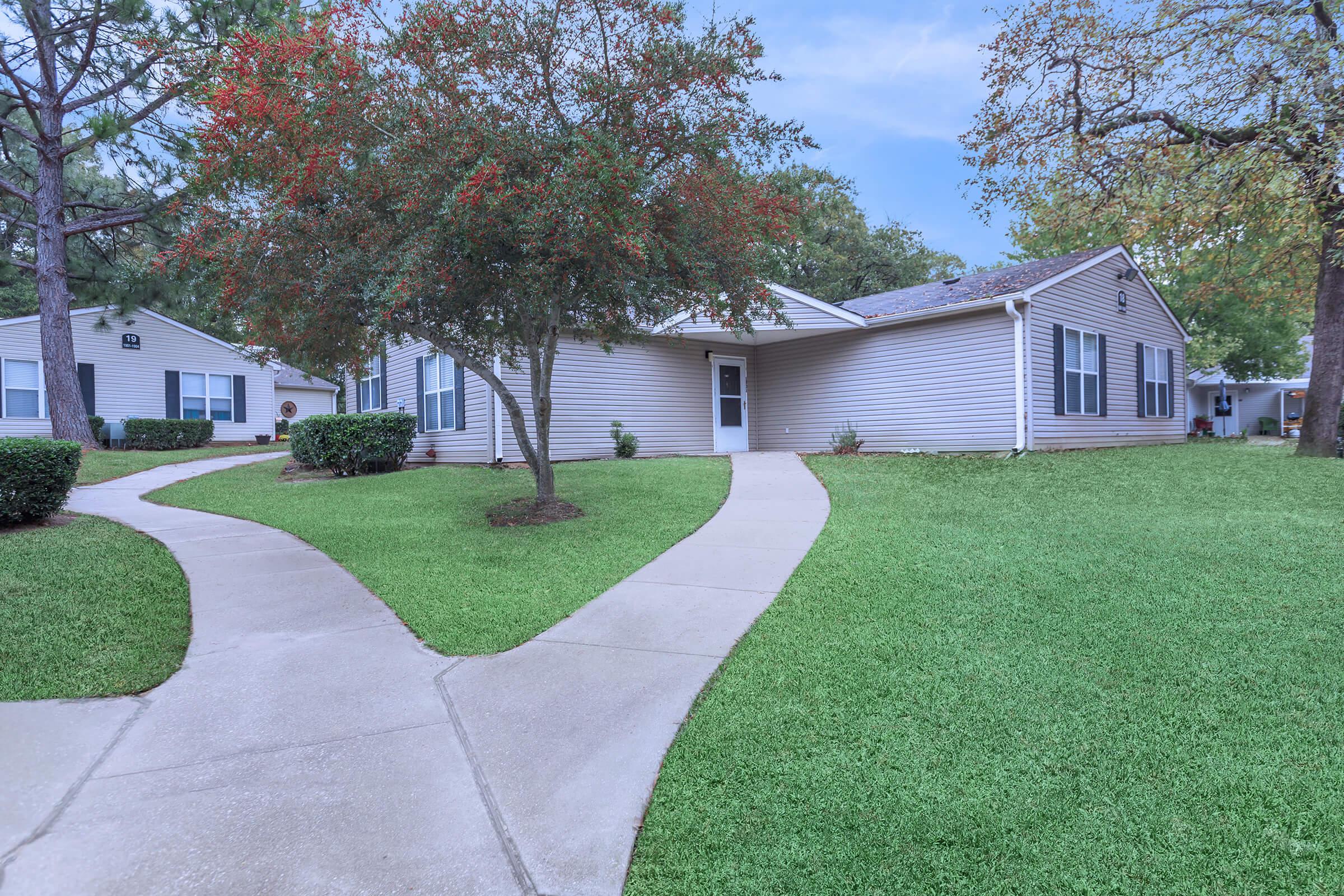 a green lawn in front of a house