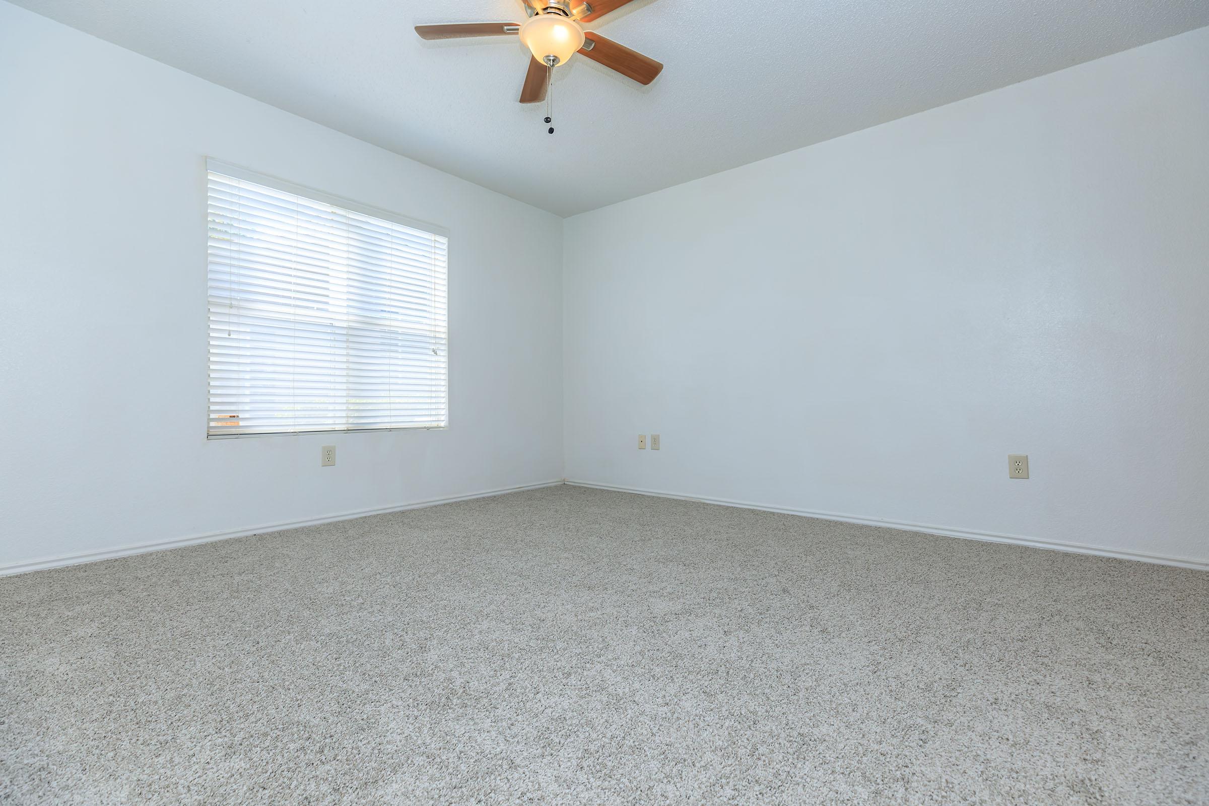 a close up of a bedroom next to a window