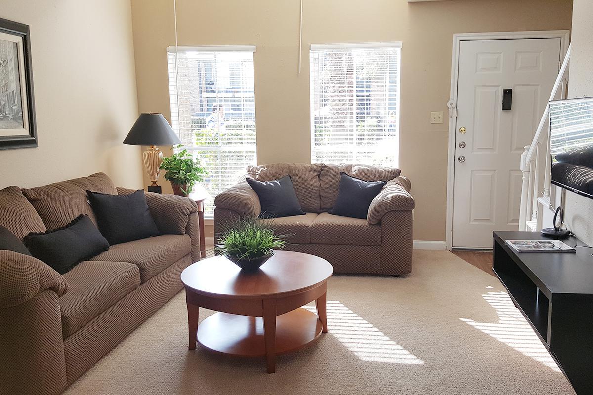 a living room filled with furniture and a flat screen tv