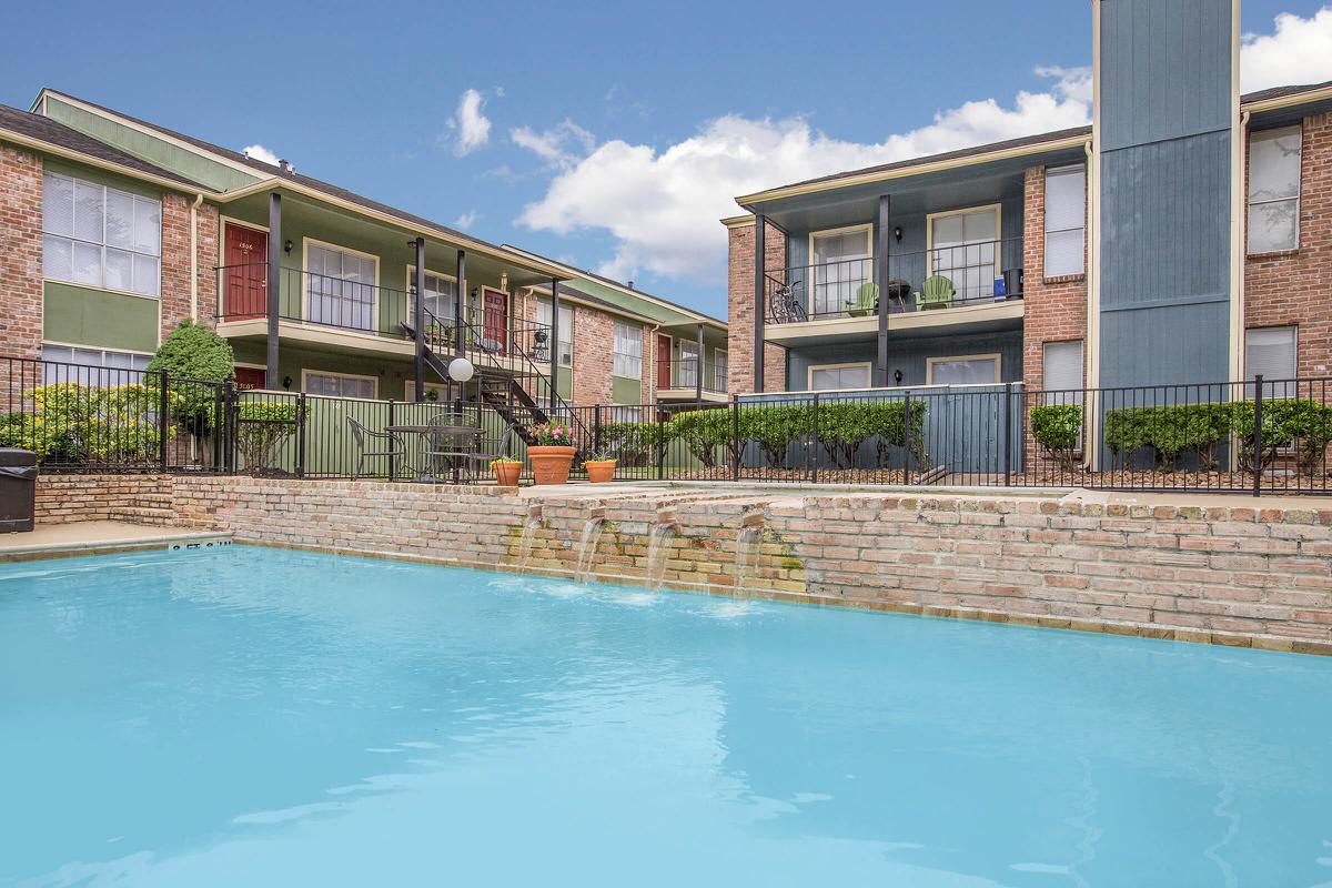 a large pool of water in front of a house