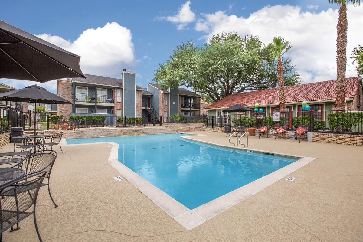 a house with a pool in front of a building