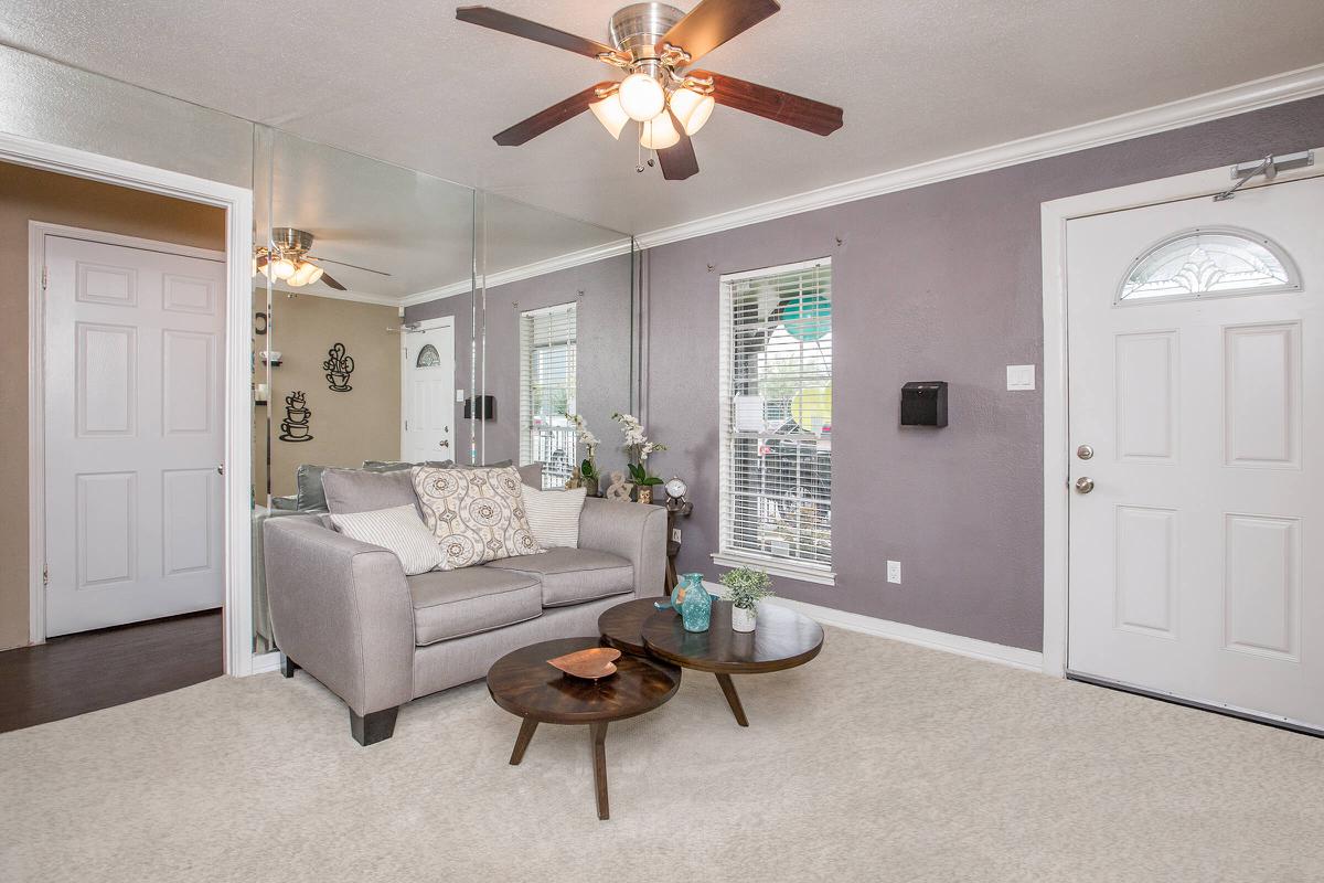 a living room filled with furniture and a large window