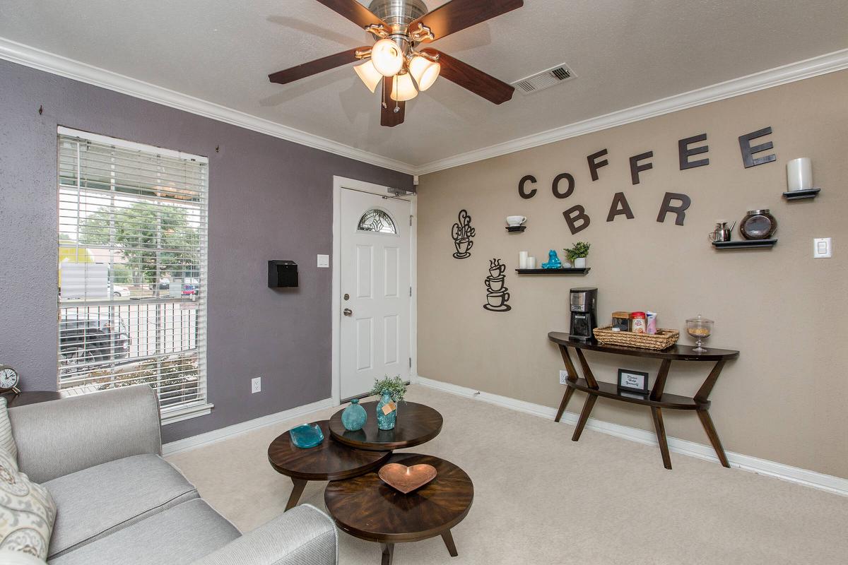 a living room filled with furniture and a large window