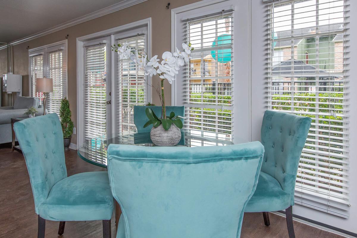 a living room filled with furniture and a large window