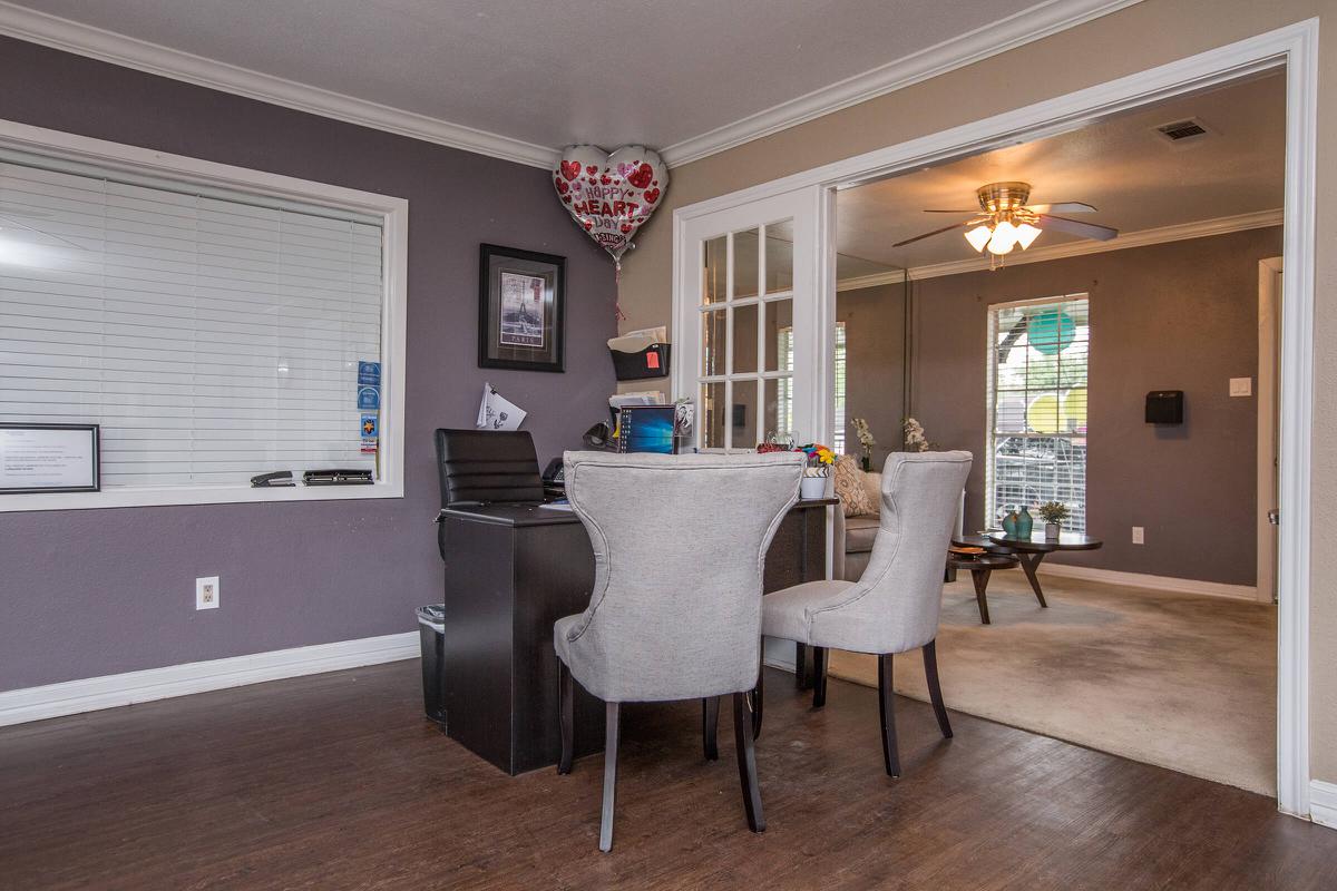 a living room filled with furniture and a large window