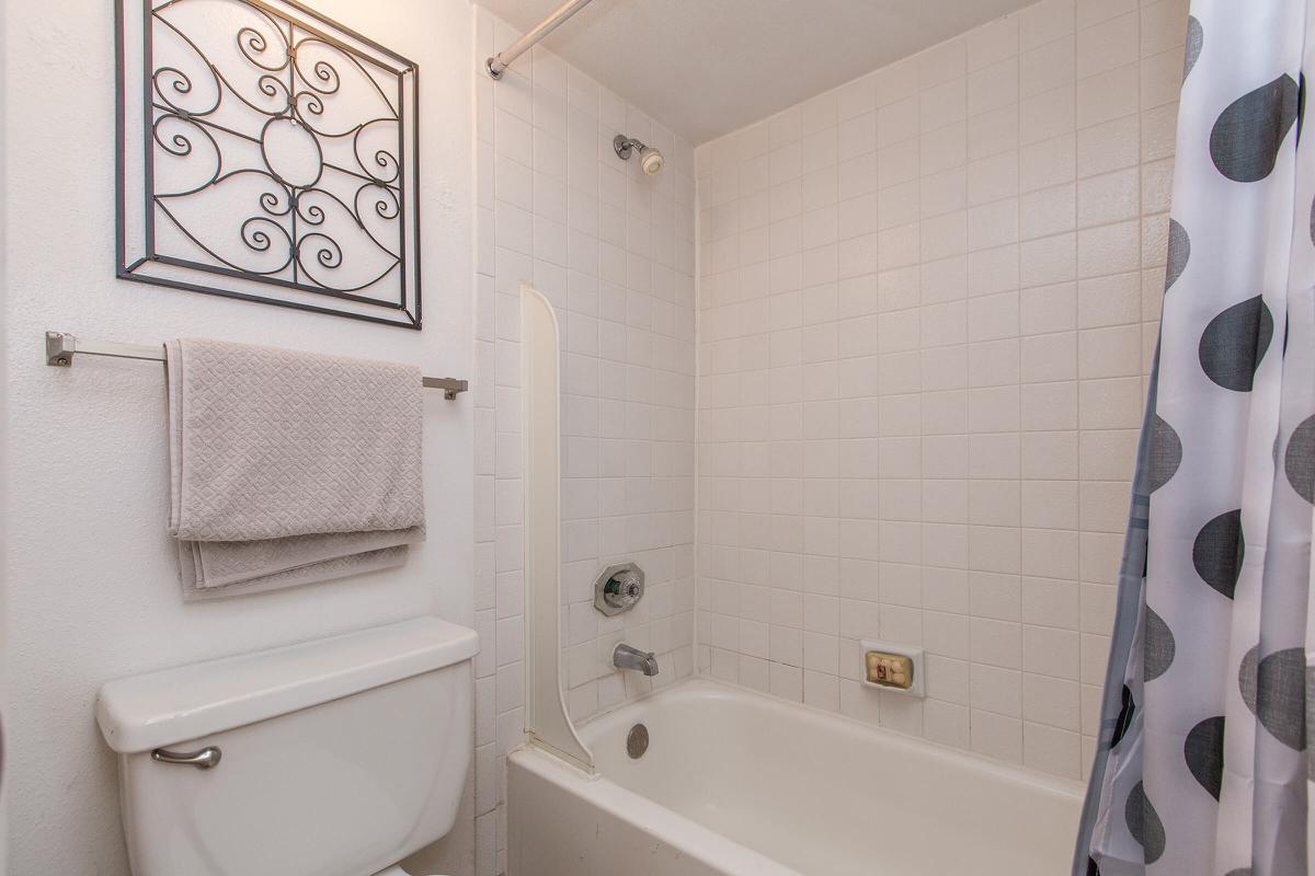 a white tub sitting next to a sink