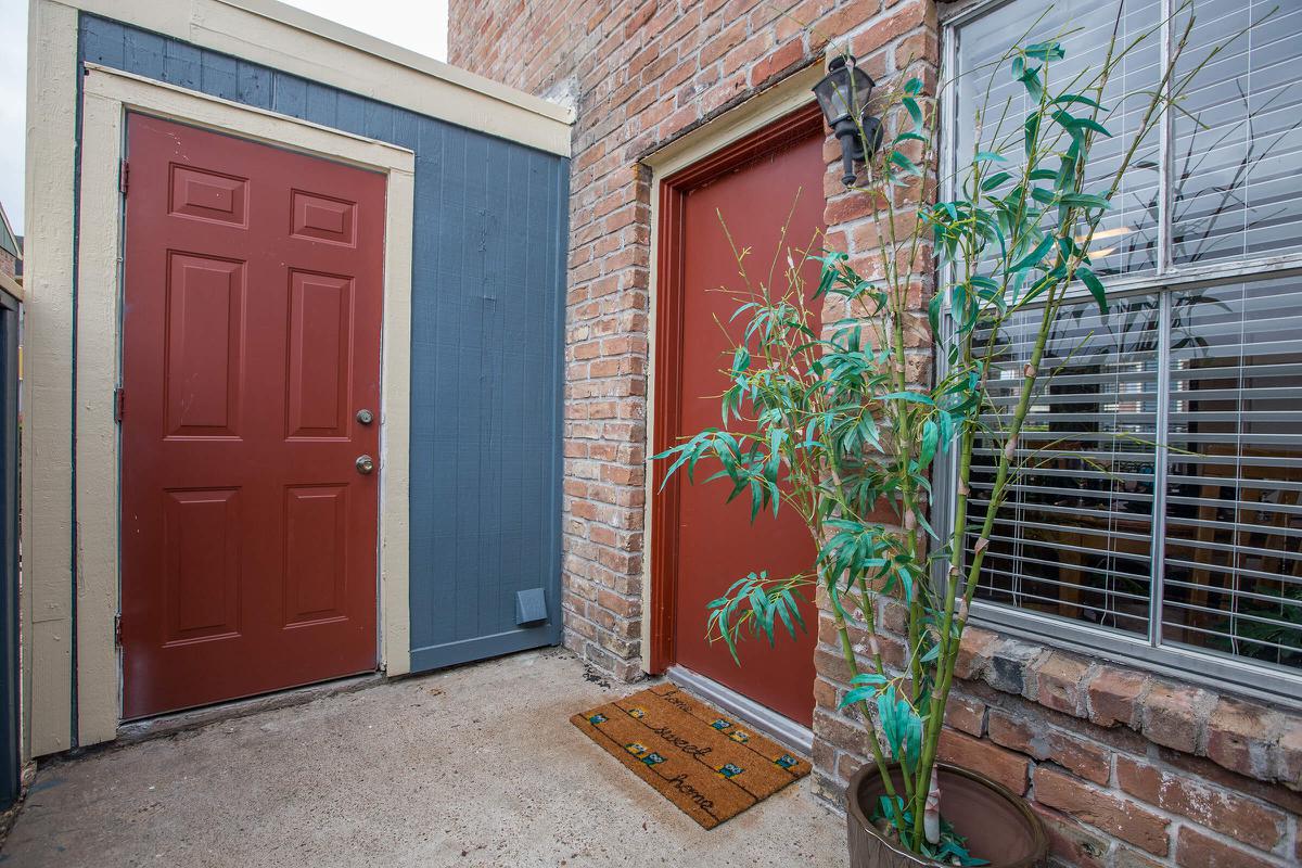 a door with a red brick building