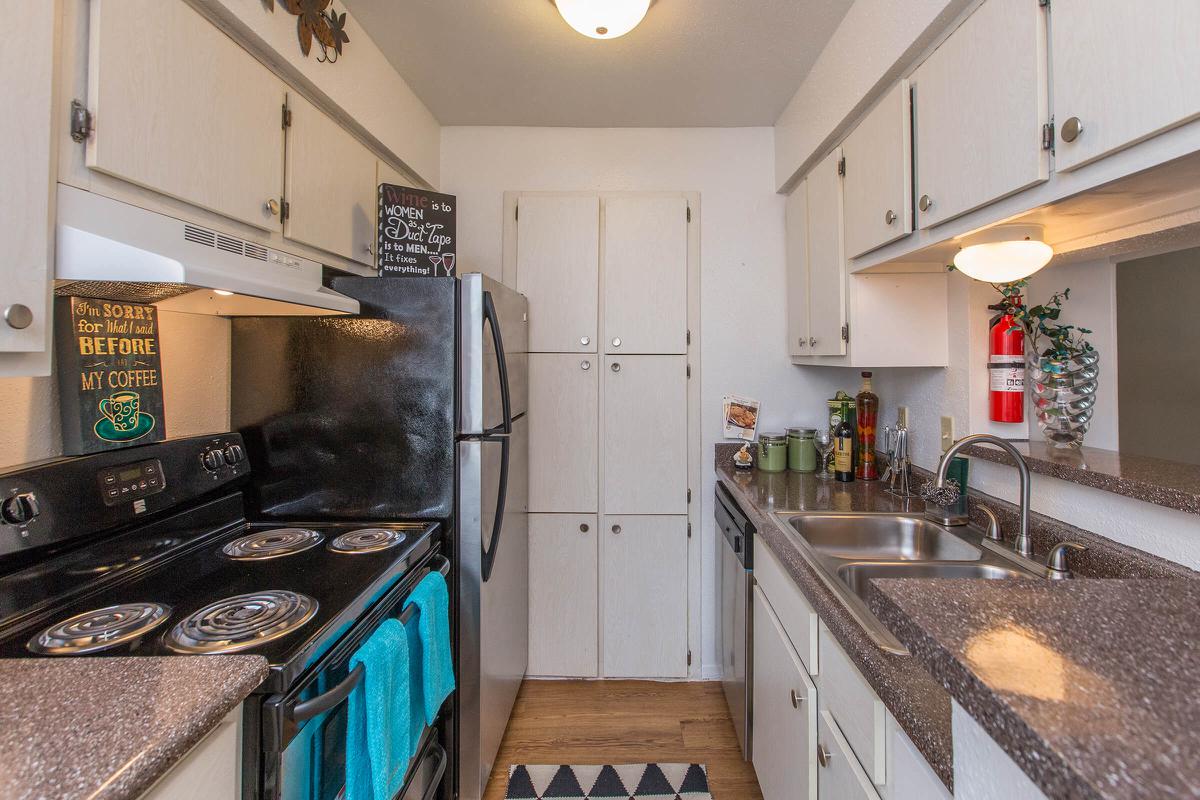 a stove top oven sitting inside of a kitchen