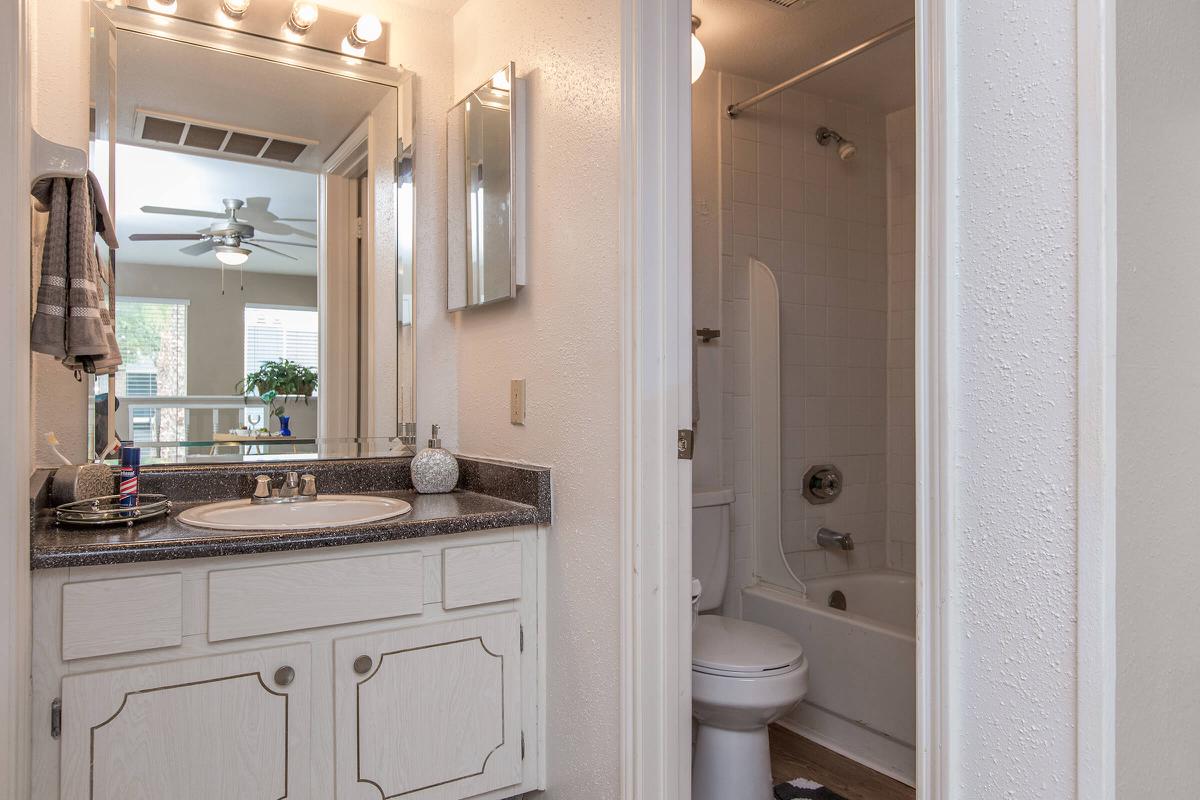 a kitchen with a sink and a mirror