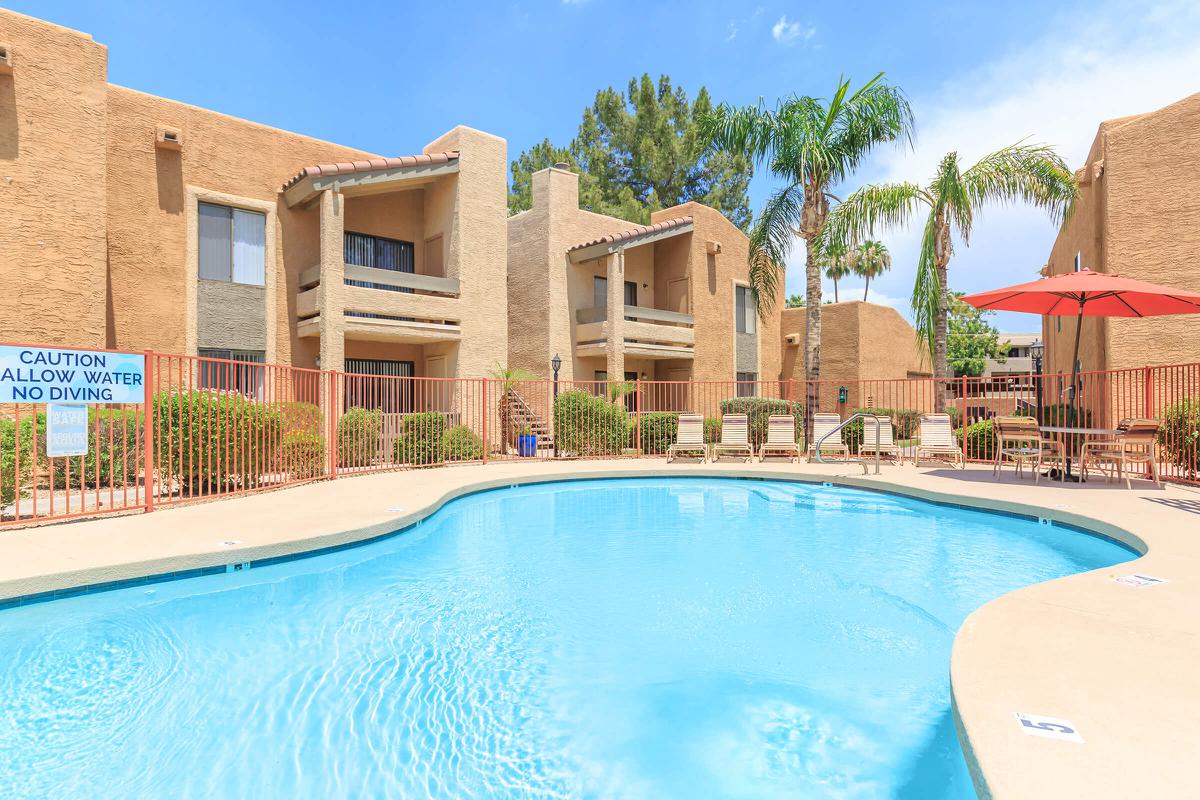 a house with a pool in front of a building