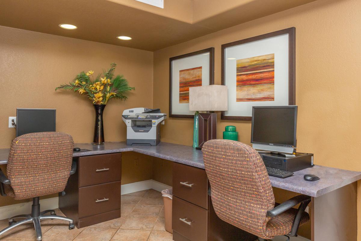 a living room with a desk and chair