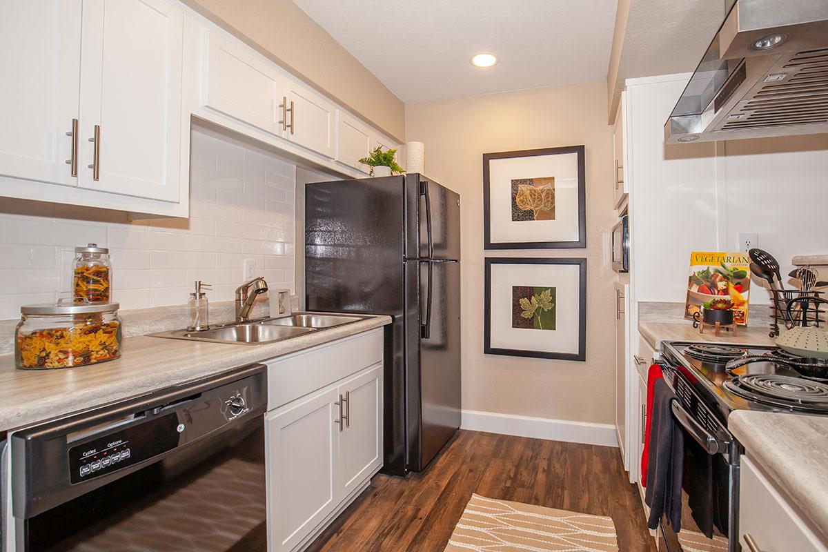 a modern kitchen with stainless steel appliances and wooden cabinets