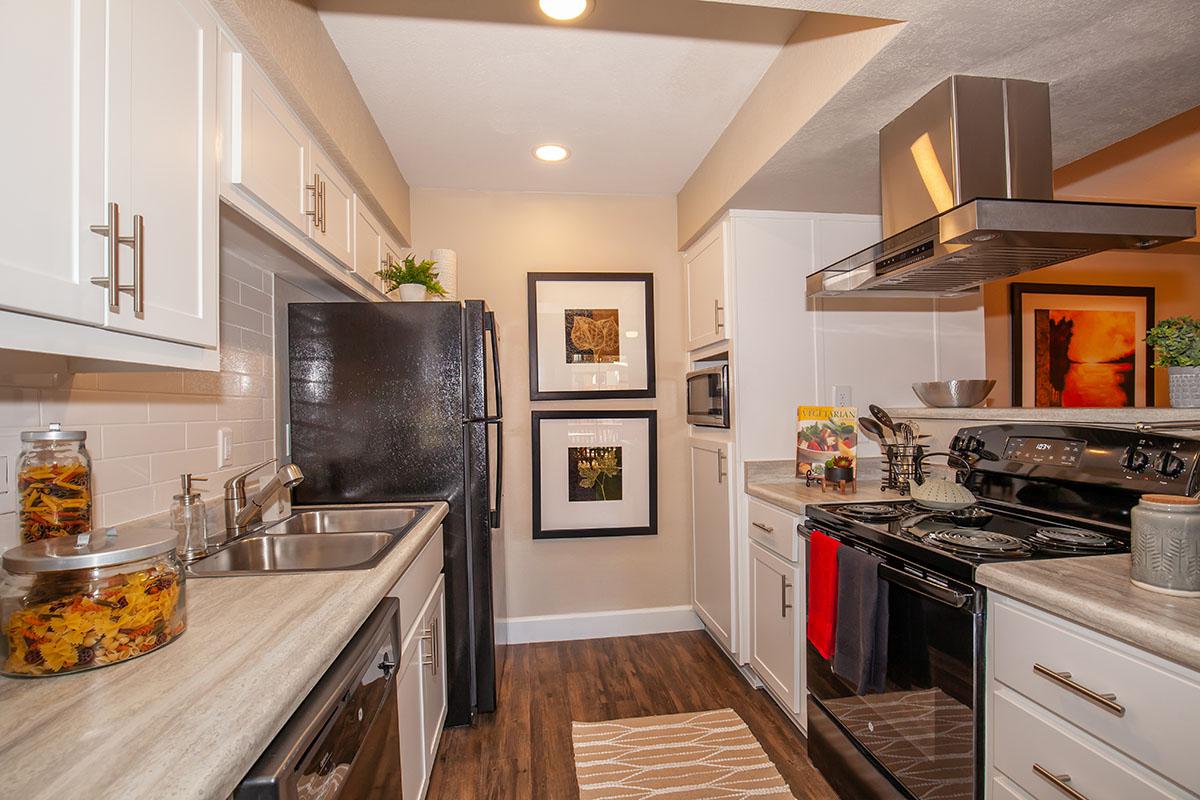 a modern kitchen with stainless steel appliances and wooden cabinets