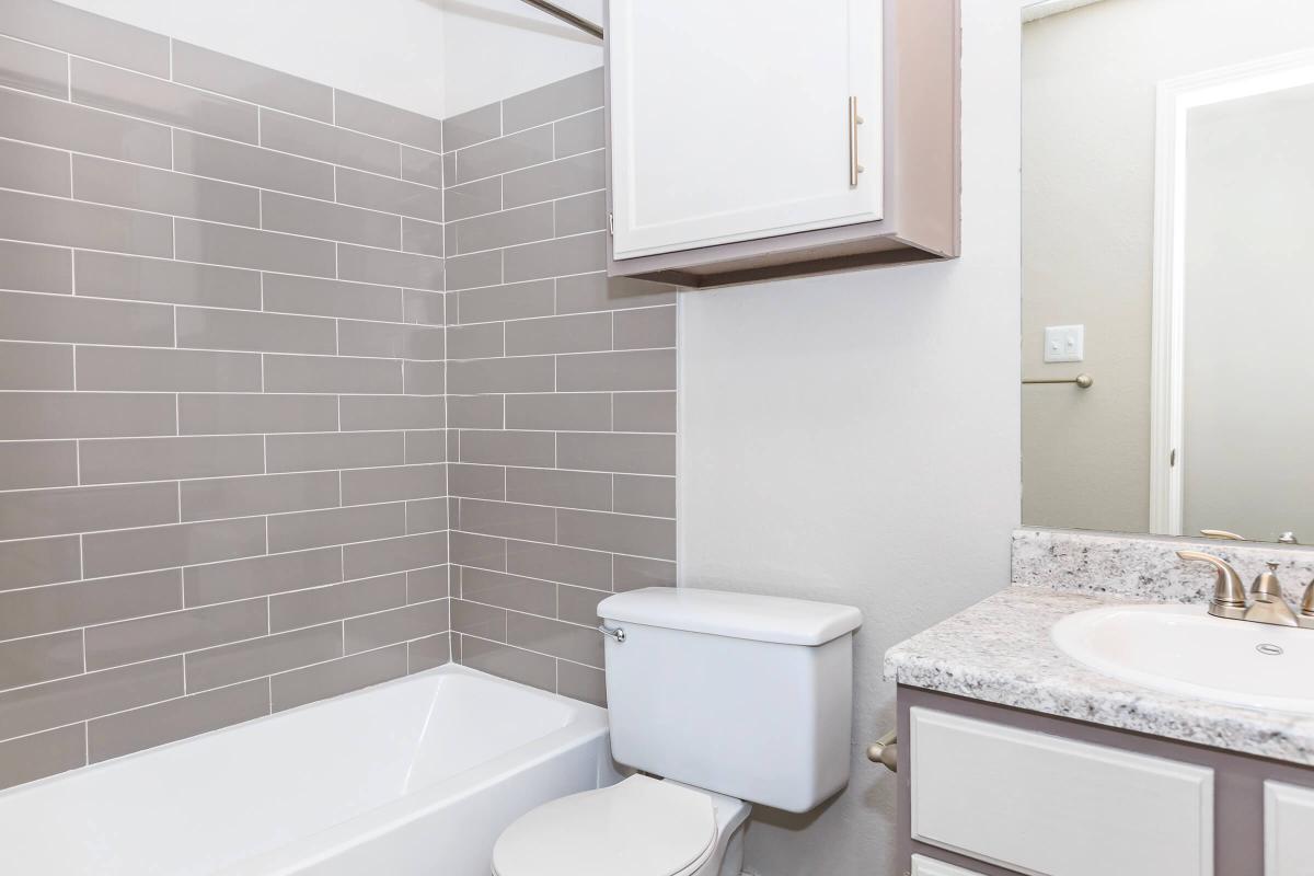 a white sink and a mirror