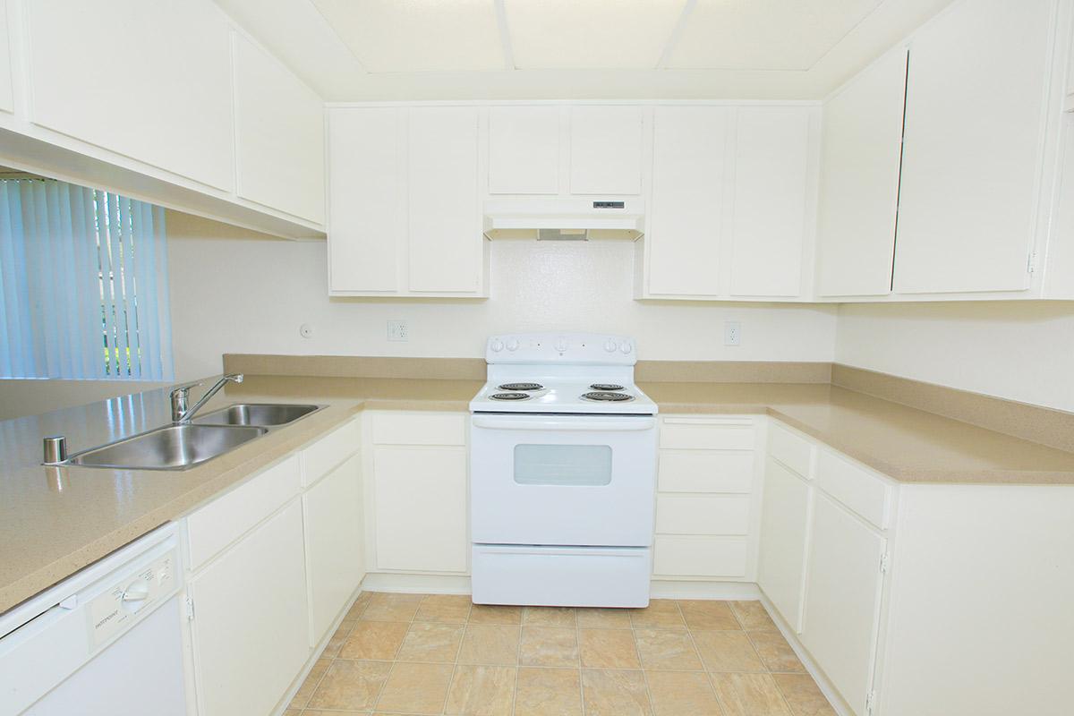 Unfurnished kitchen with white appliances