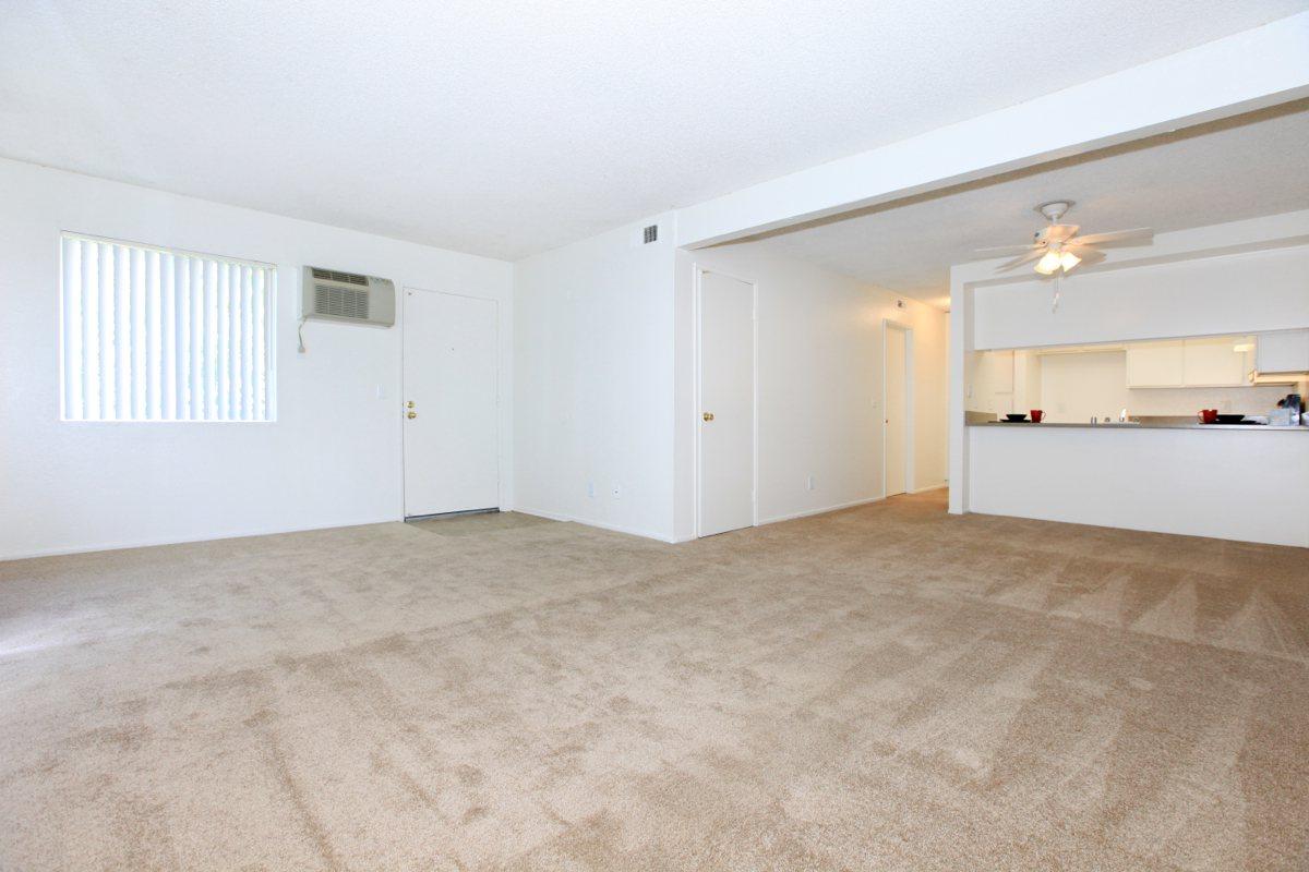 Unfurnished living room and dining room with carpet