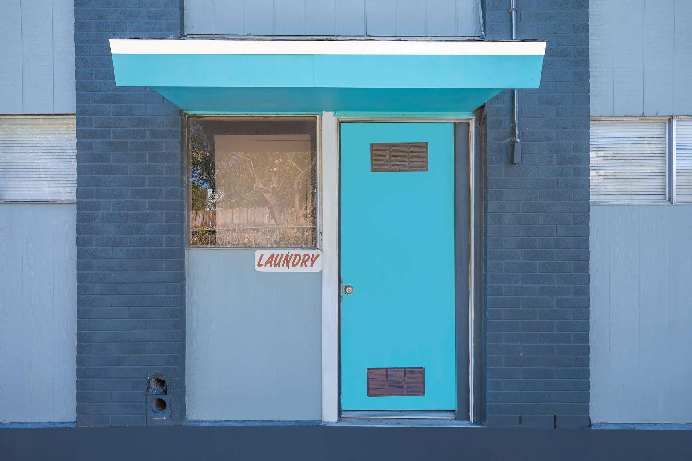 a blue sign sitting on the side of a building