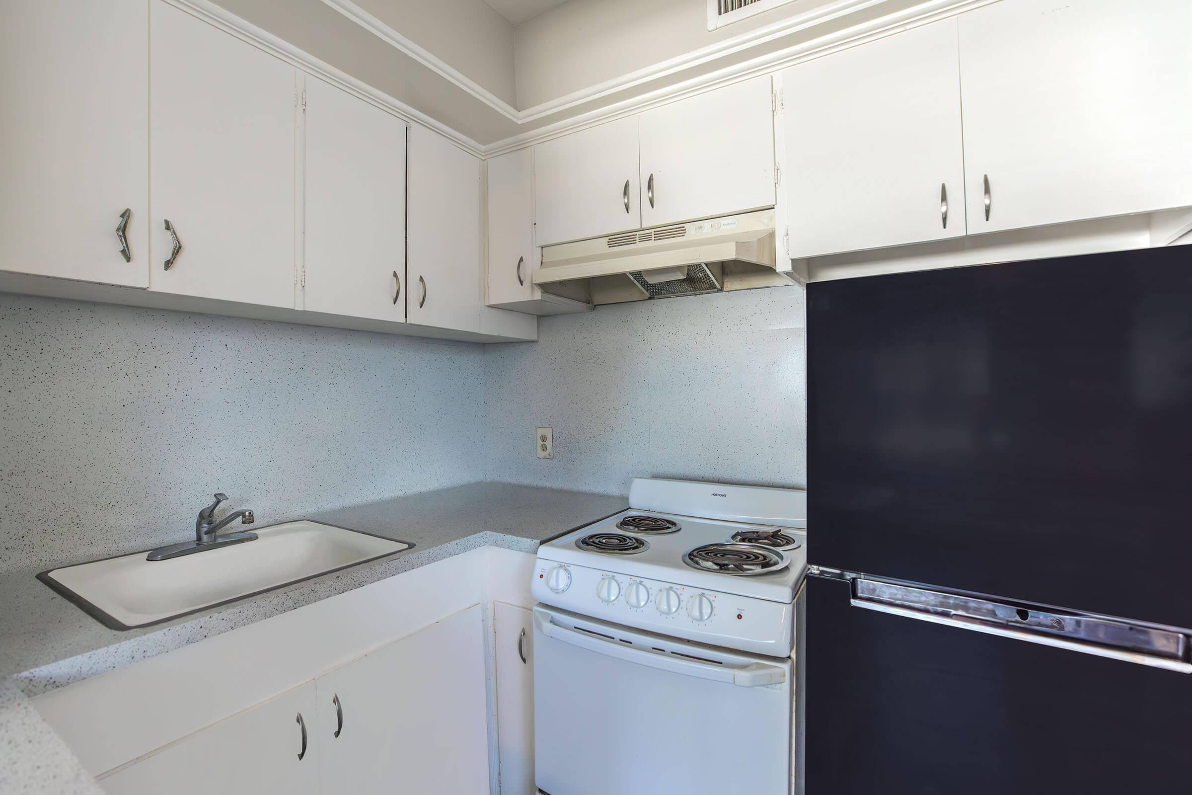 a kitchen with a stove and a sink