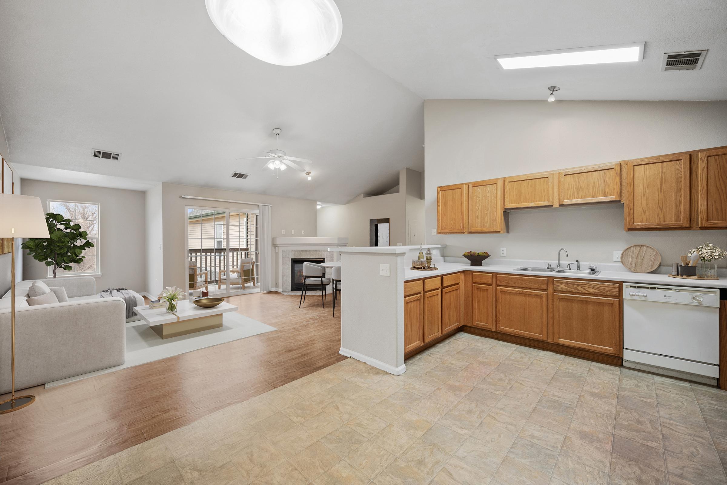 kitchen and living room with balcony door sink and cabinets.