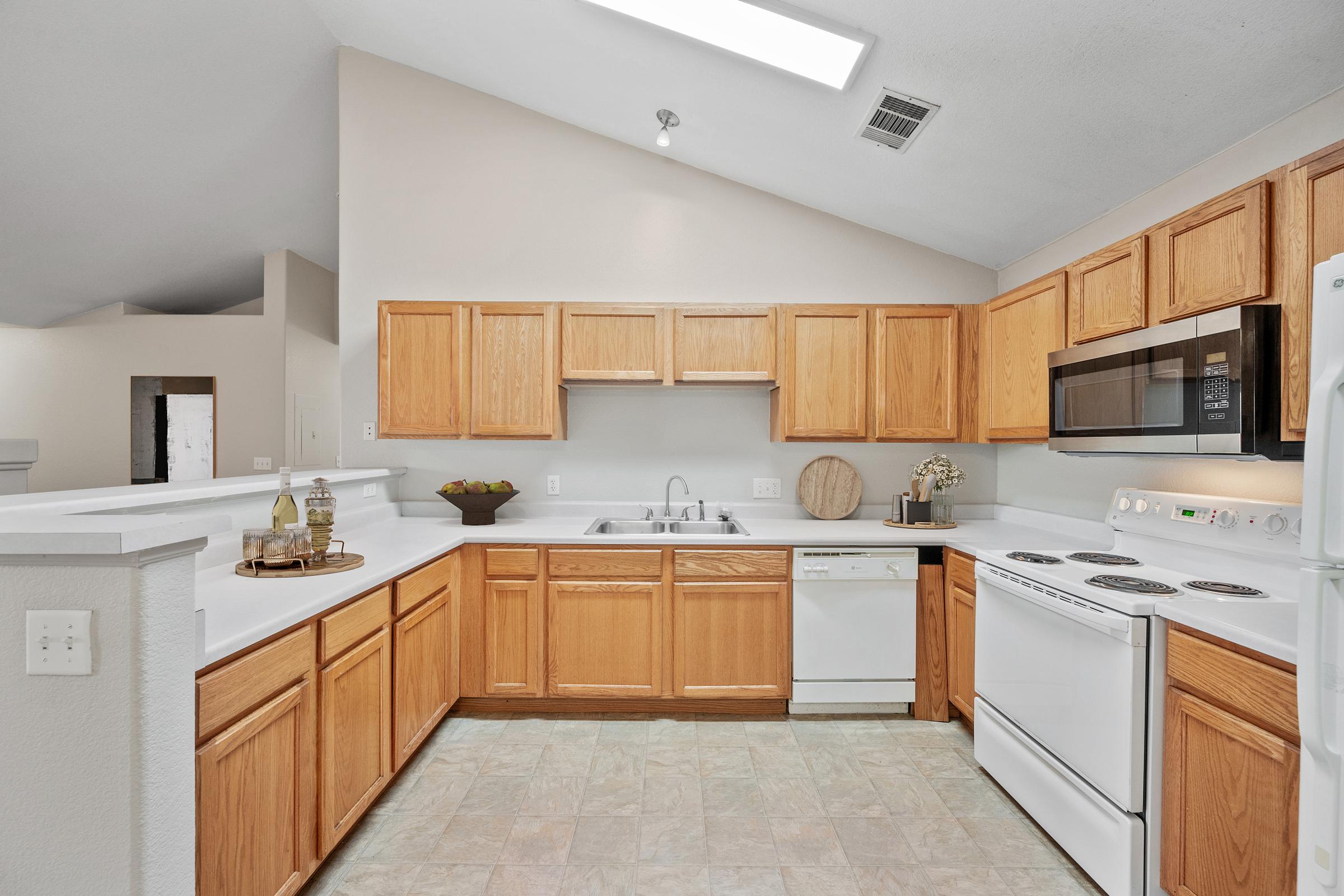 kitchen with sink dishwasher microwave stove and cabinets.