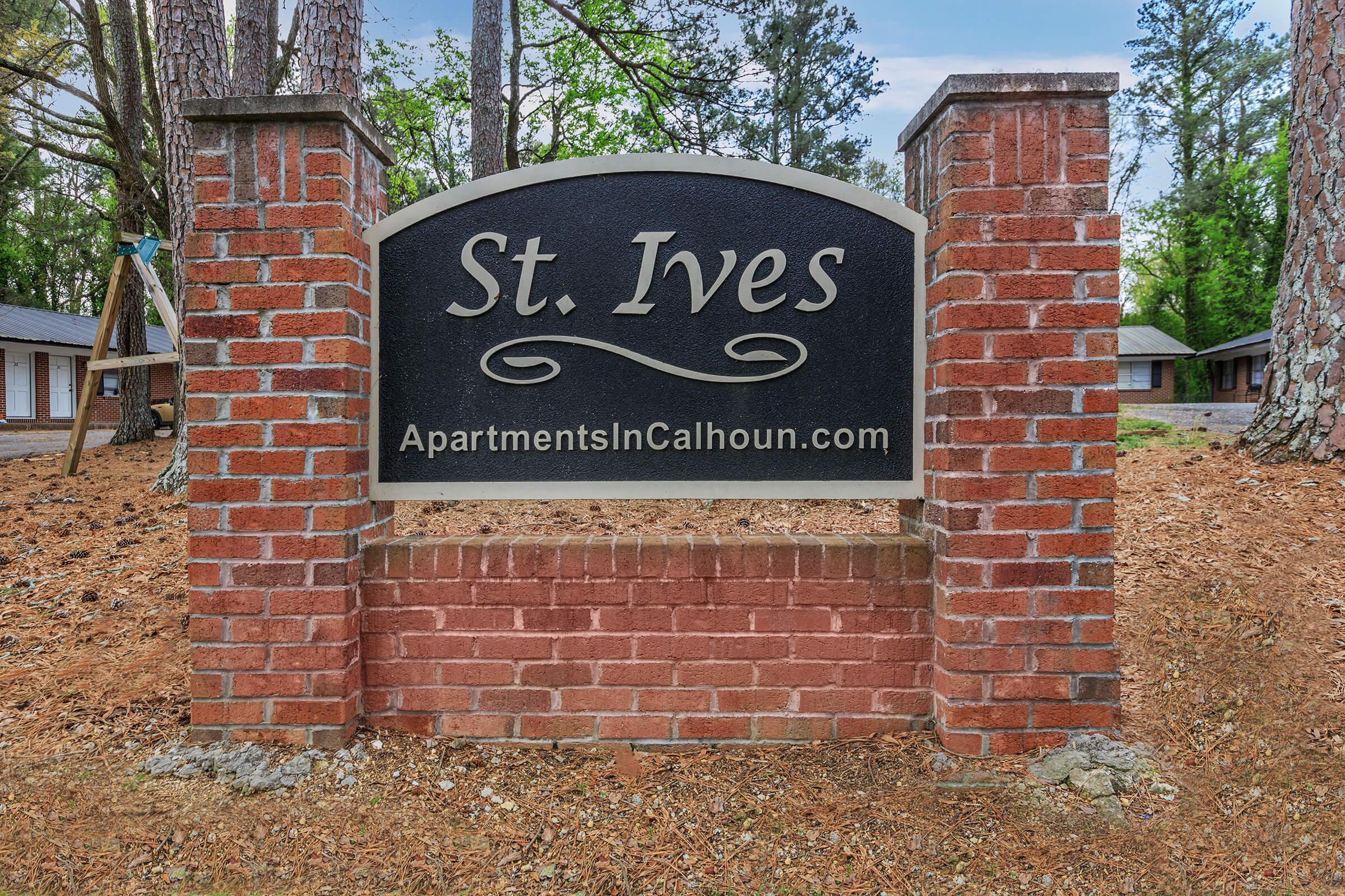 a sign in front of a brick building