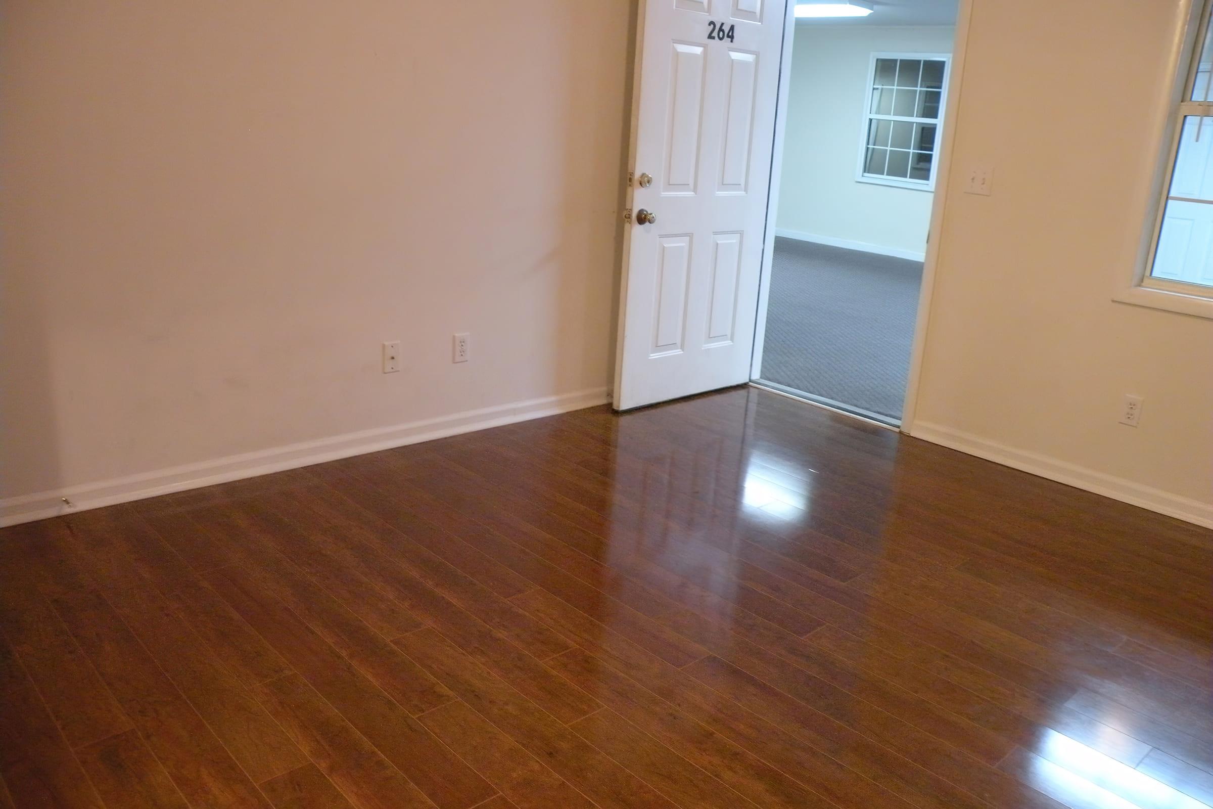 a close up of a hard wood floor next to a window